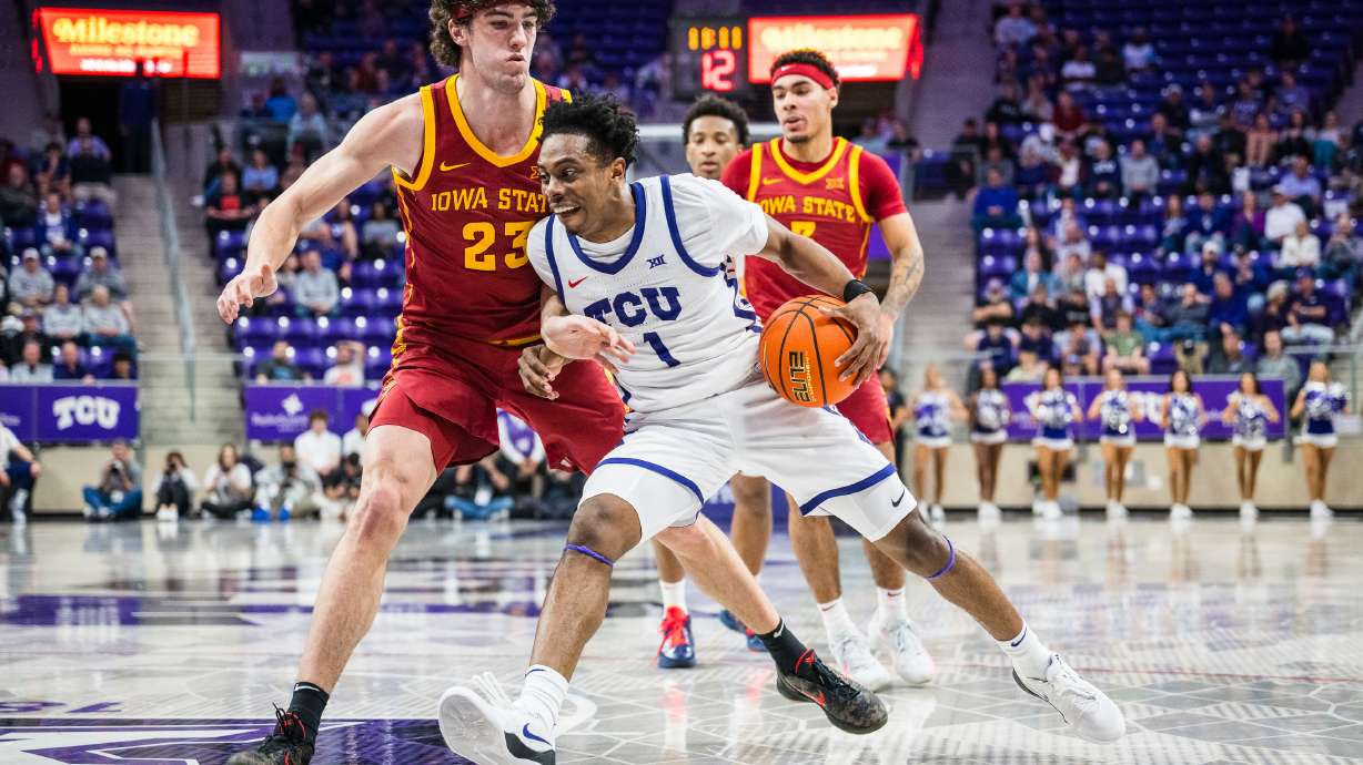 TCU guard Jayden Pierre (1) drives the ball against Iowa State forward Blake Buchanan (23) during an NCAA college basketball game, Tuesday, Feb. 10, 2026, Fort Worth, Texas.