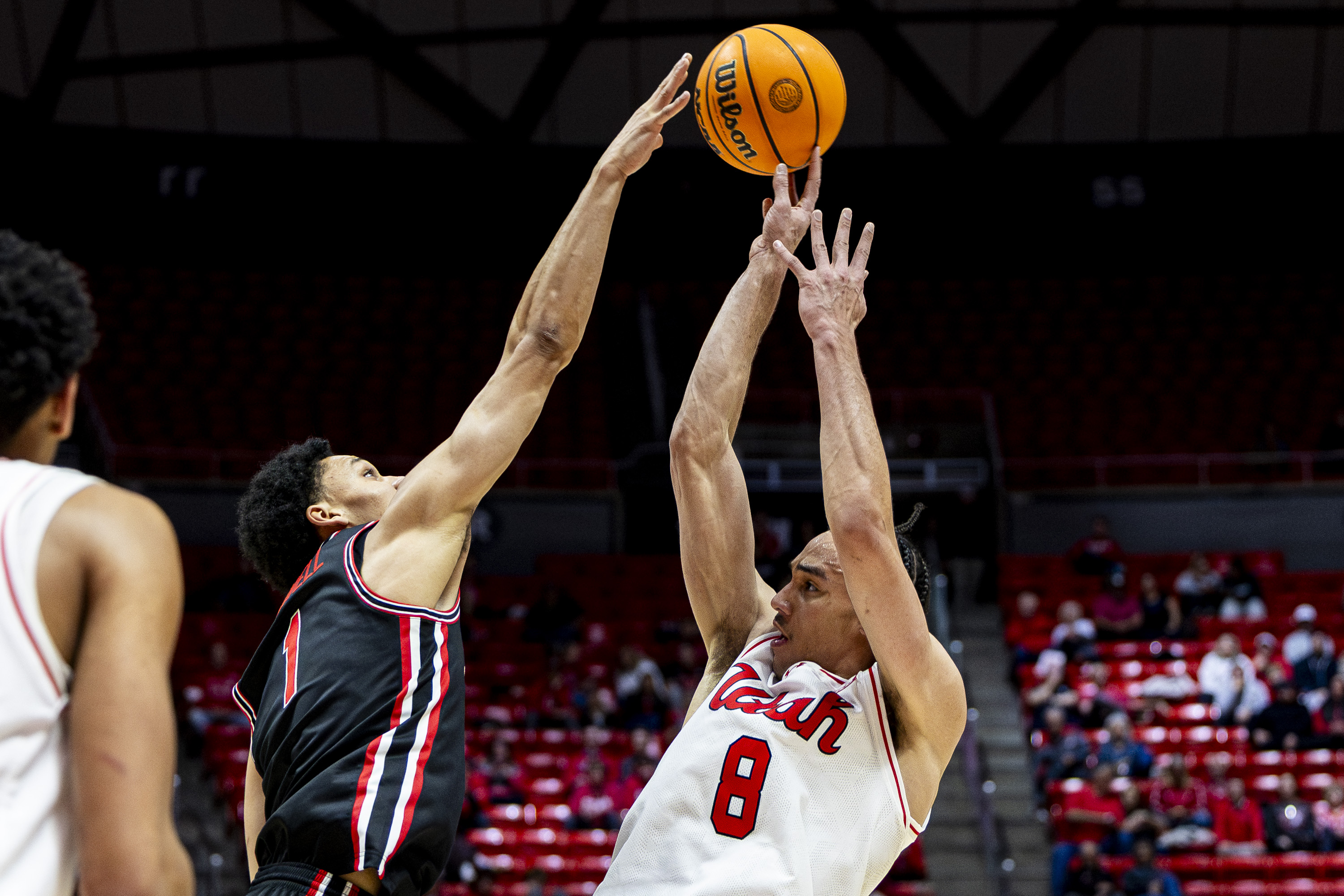Utah forward Keanu Dawes (8) shoots the ball while guarded by Houston guard Isiah Harwell (1) during an NCAA basketball game held at the Huntsman Center in Salt Lake City on Tuesday, Feb. 10, 2026.