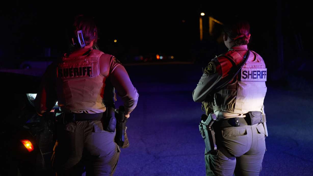 Sheriff's officials block the entrance to a road where a home was being searched in Rio Rico, Ariz., on Tuesday, in connection with the investigation of Nancy Guthrie's disappearance.