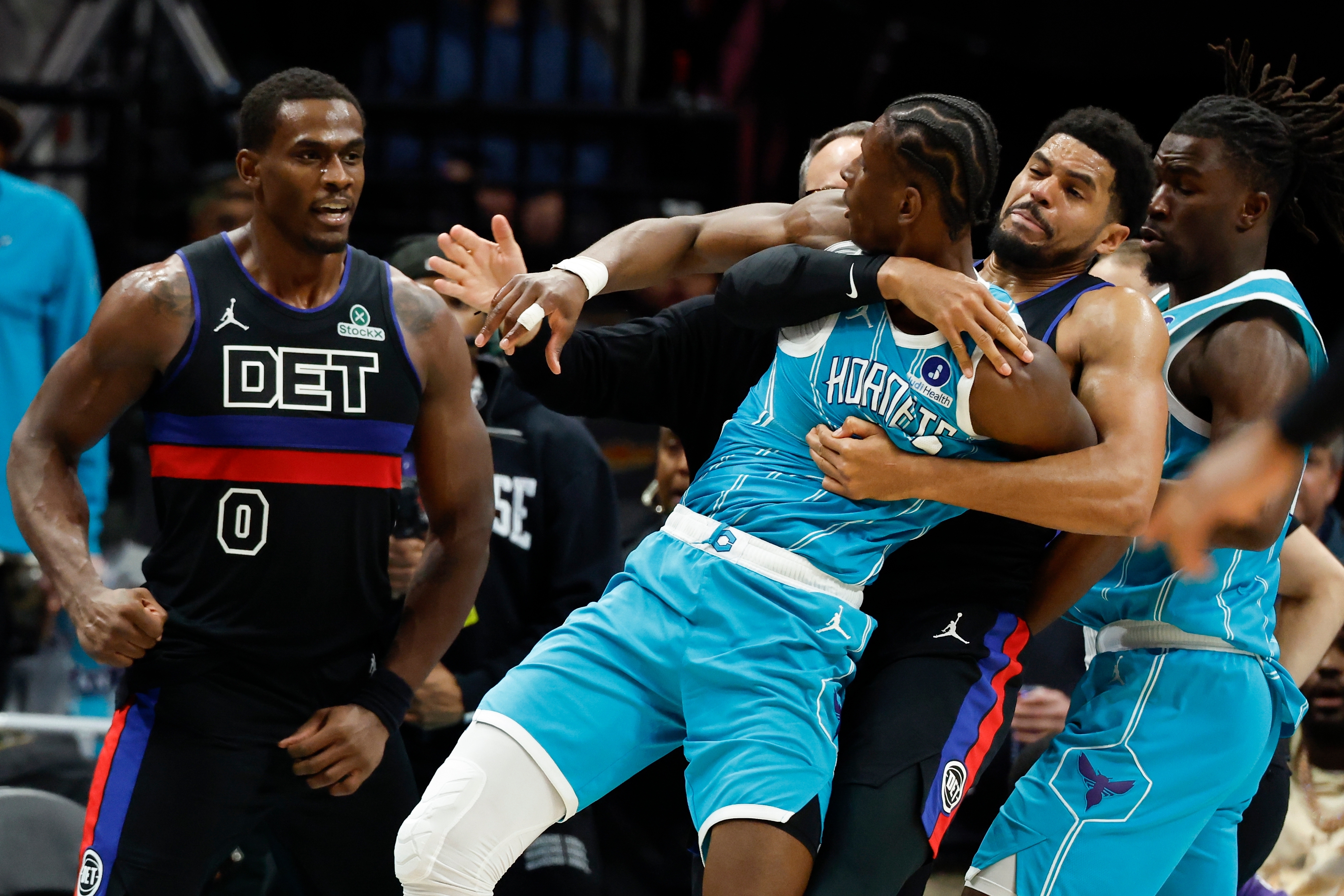 Charlotte Hornets forward Moussa Diabate, front right, is held back as he fights with Detroit Pistons center Jalen Duren (0) fight during the second half of an NBA basketball game in Charlotte, N.C., Monday, Feb. 9, 2026. 