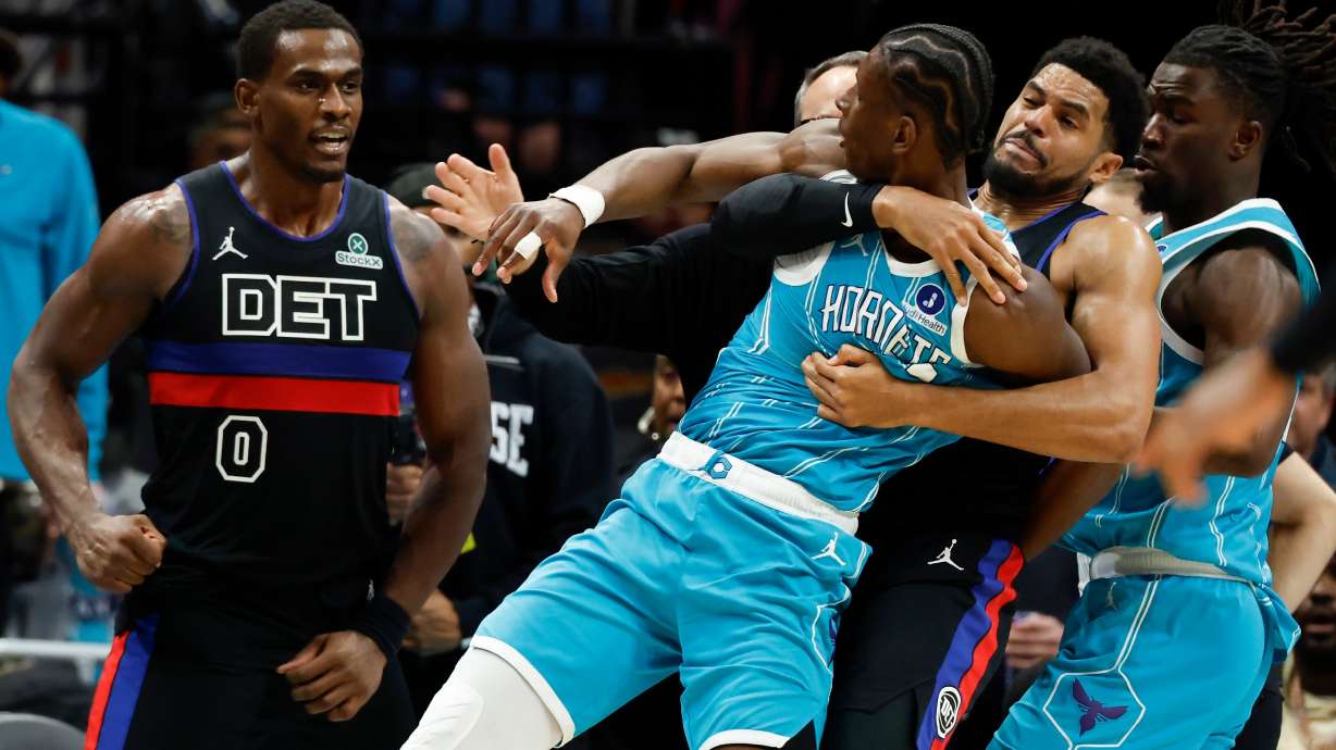 Charlotte Hornets forward Moussa Diabate, front right, is held back as he fights with Detroit Pistons center Jalen Duren (0) fight during the second half of an NBA basketball game in Charlotte, N.C., Monday, Feb. 9, 2026.