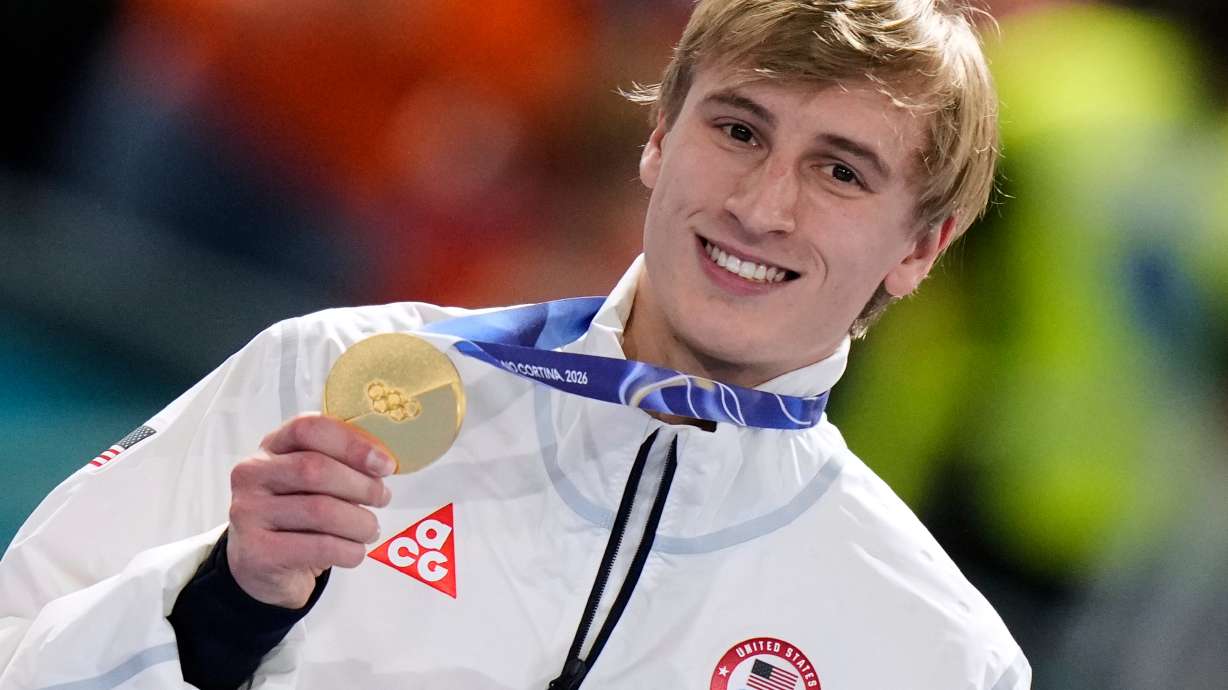Jordan Stolz of the U.S. celebrates with his gold medal on the podium of the men's 1,000 meters speedskating race at the 2026 Winter Olympics, in Milan, Italy, Wednesday, Feb. 11, 2026.