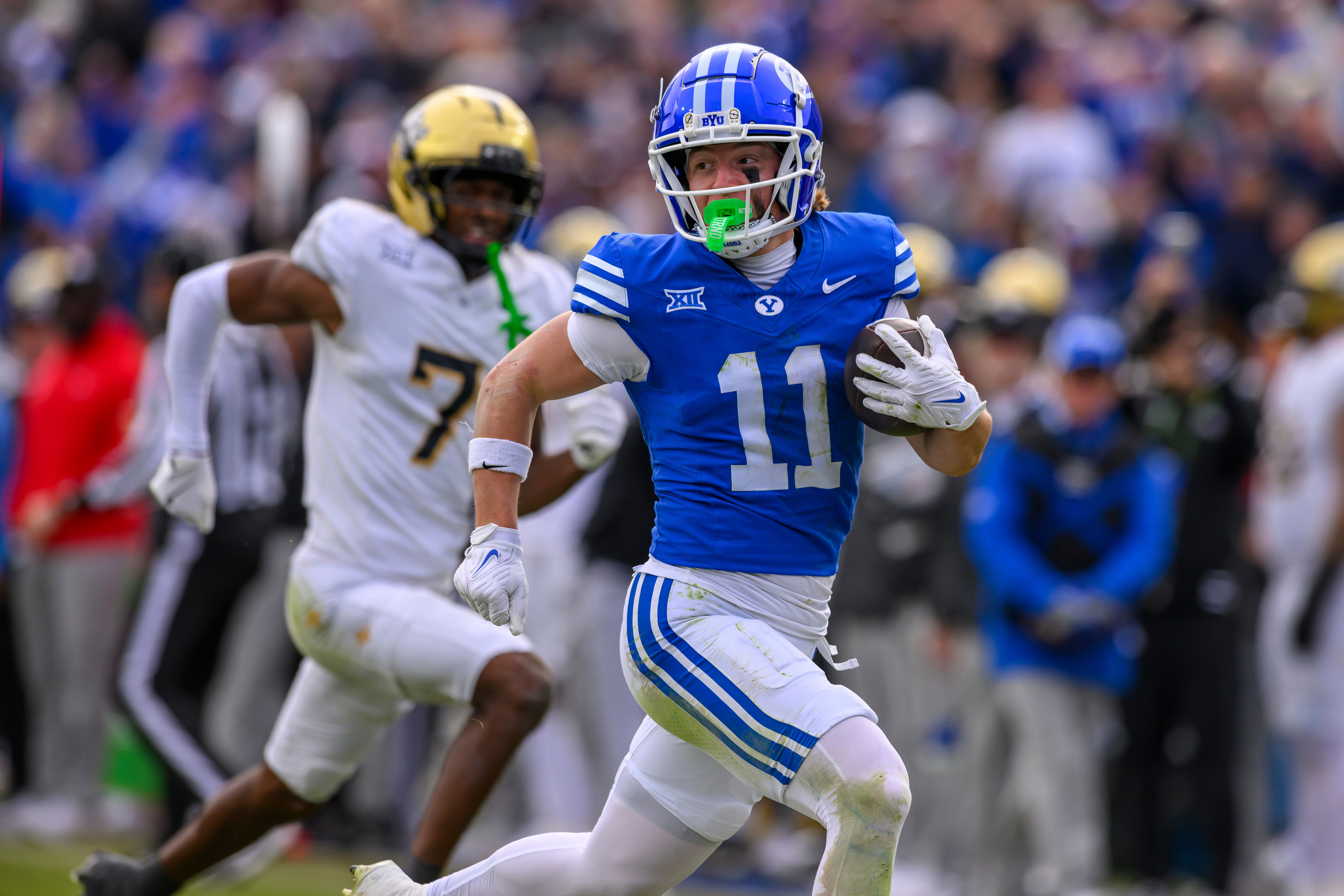 FILE - BYU wide receiver Parker Kingston (11) runs the ball in for a touchdown during the second half an NCAA college football game against UCF, Nov. 29, 2025, in Provo, Utah. 