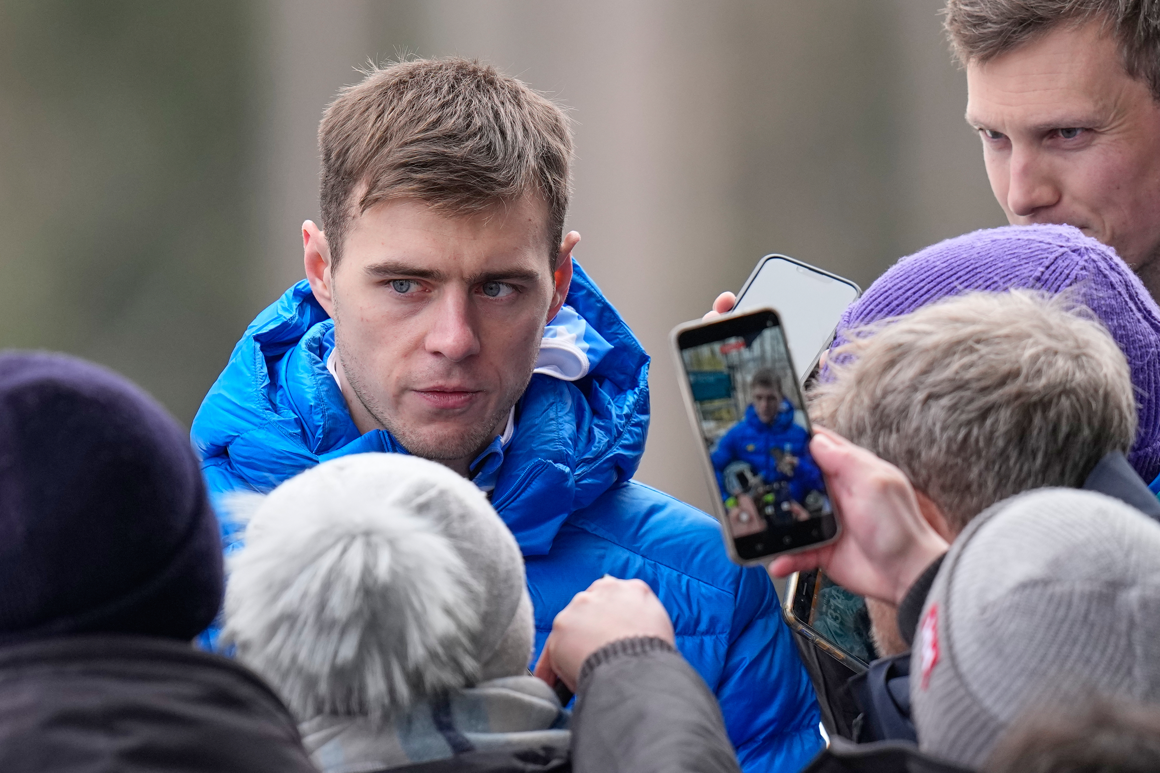 Ukraine's Vladyslav Heraskevych, left, talks to the media during a men's skeleton training session at the 2026 Winter Olympics, in Cortina d'Ampezzo, Italy, Wednesday, Feb. 11, 2026. 