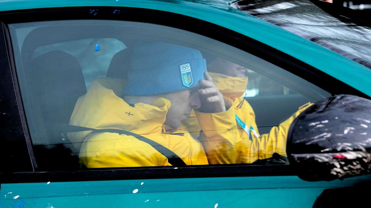 Ukrainian skeleton athlete Vladyslav Heraskevych sits in a car at the sliding center at the 2026 Winter Olympics, in Cortina d'Ampezzo, Italy, Thursday, Feb. 12, 2026.