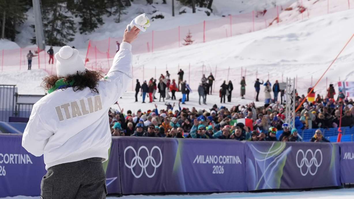 Italy's Federica Brignone, gold medalist in an alpine ski, women's super-G race, waves to supporters at the 2026 Winter Olympics, in Cortina d'Ampezzo, Italy, Thursday, Feb. 12, 2026.