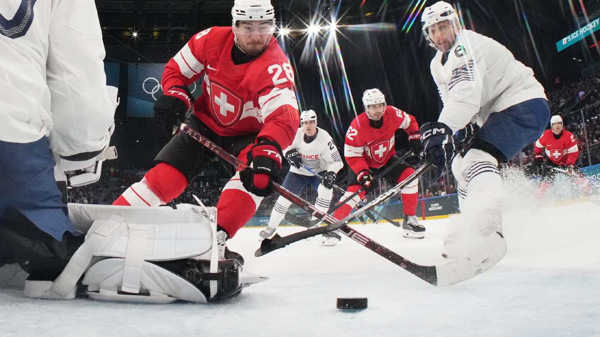Switzerland's Timo Meier, center, scores his sides third goal past France's goalkeeper Antoine Keller during a preliminary round match of men's ice hockey between Switzerland and France at the 2026 Winter Olympics, in Milan, Italy, Thursday, Feb. 12, 2026.