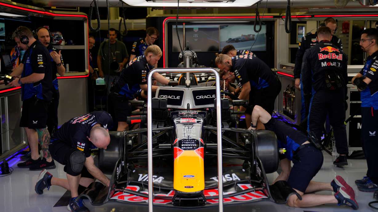 Mechanics of Red Bull driver Max Verstappen of the Netherlands prepare his car during a Formula One pre-season test at the Bahrain International Circuit in Sakhir, Bahrain, Wednesday, Feb. 11, 2026.