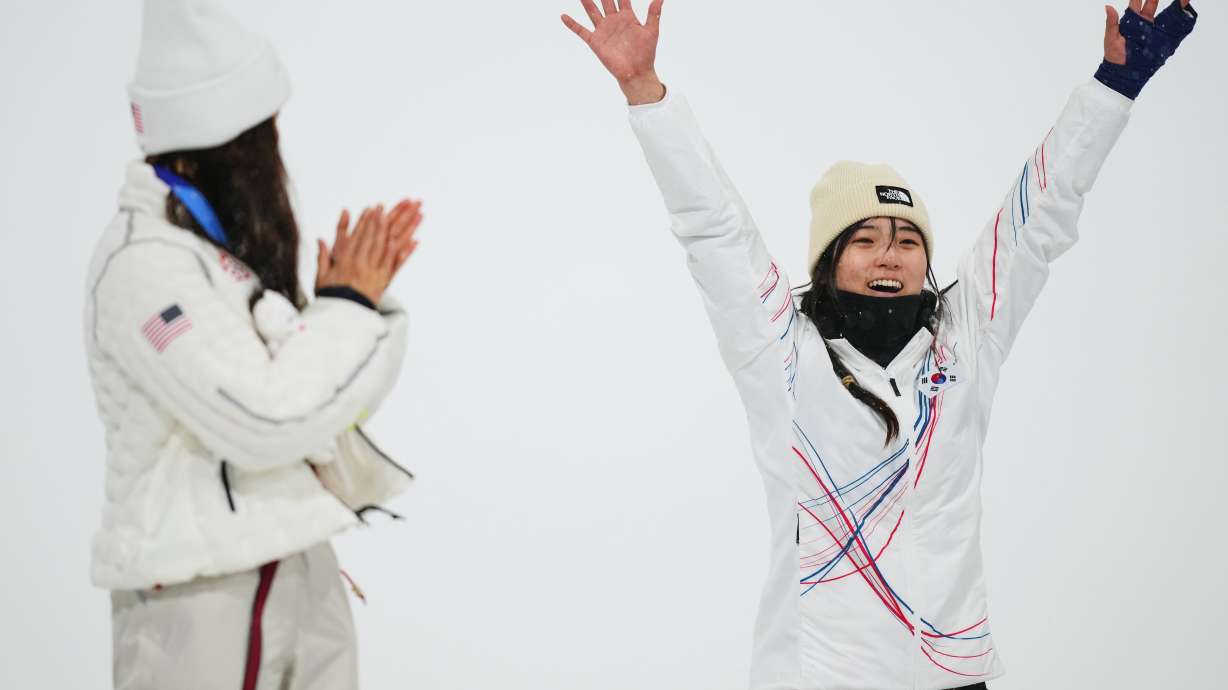 Silver medalist United States' Chloe Kim, left, claps as gold medalist South Korea's Choi Ga-on celebrates winning the the women's snowboarding halfpipe finals at the 2026 Winter Olympics, in Livigno, Italy, Thursday, Feb. 12, 2026.