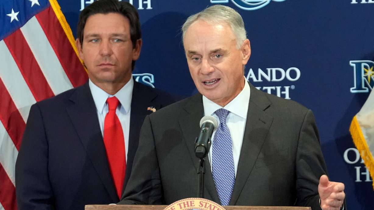 Major League Baseball commissioner Rob Manfred, right, speaks during a new baseball stadium news conference as Florida Gov. Ron DeSantis looks, Tuesday, Feb. 3, 2026, at Hillsborough College in Tampa, Fla.