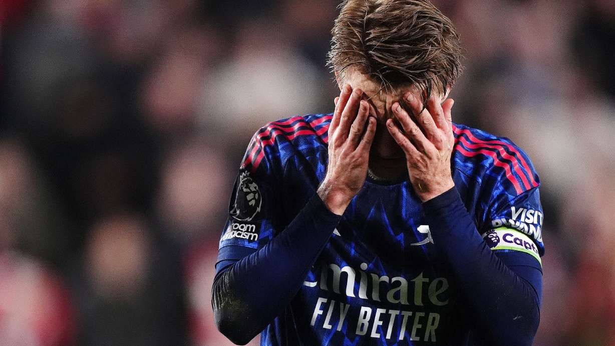 Arsenal's Martin Odegaard reacts after getting injured attempting to prevent Brentford's Keane Lewis-Potter from scoring during the English Premier League soccer match between Brentford and Arsenal in London, Thursday, Feb. 12, 2026.