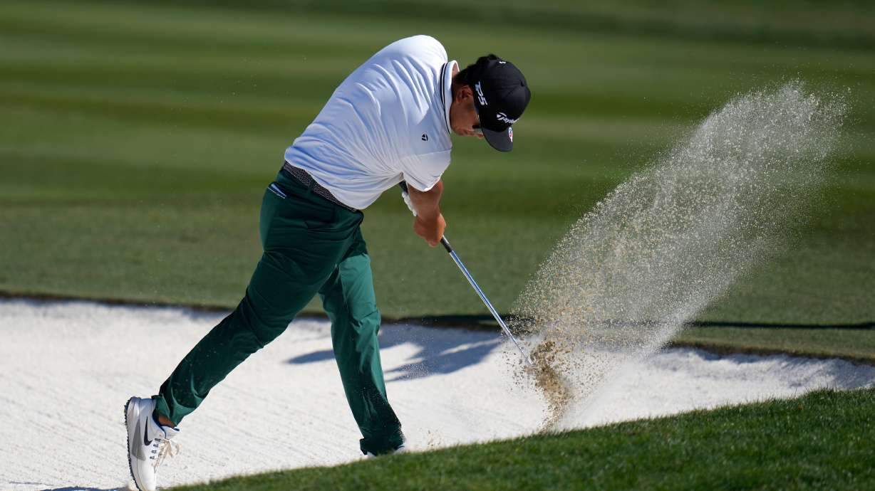 Ryo Hisatsune, of Japan, slams his club into the sand of a fairway bunker at the 10th hole after hitting a shot during the final round of the Phoenix Open golf tournament Sunday, Feb. 8, 2026, in Scottsdale, Ariz.