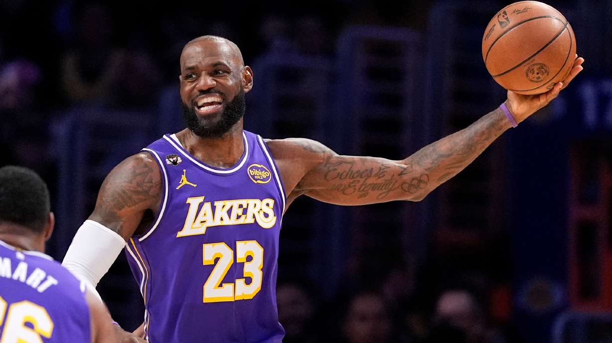 Los Angeles Lakers forward LeBron James smiles as he tries to pass during the first half of an NBA basketball game against the Dallas Mavericks, Thursday, Feb. 12, 2026, in Los Angeles.