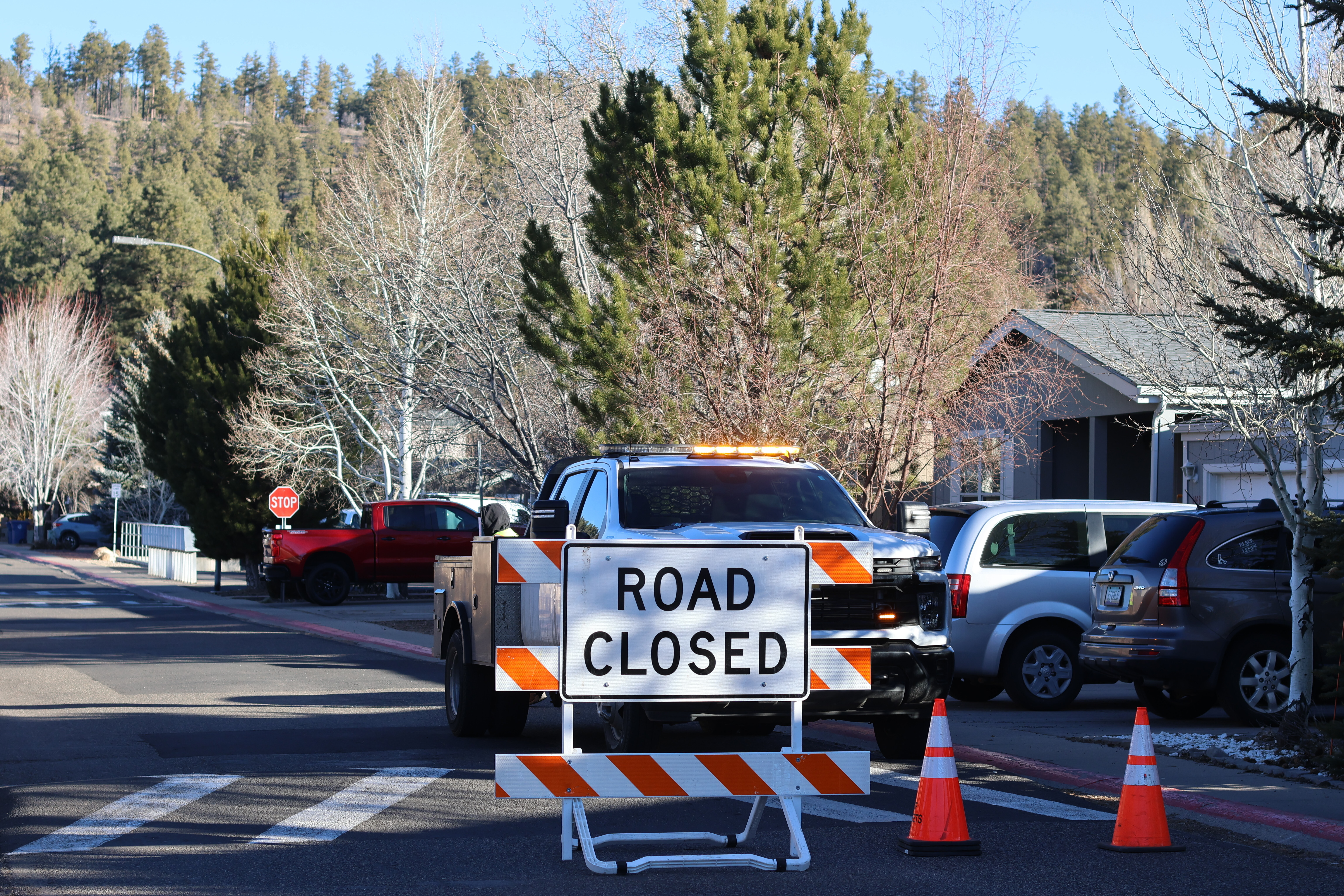 The blocked road to a neighborhood in Flagstaff, Arizona, where police say a man opened fire at officers, Feb. 5. A grand jury indicted 50-year-old Terrell Storey on two counts of first-degree felony murder and dozens of other charges on Friday.