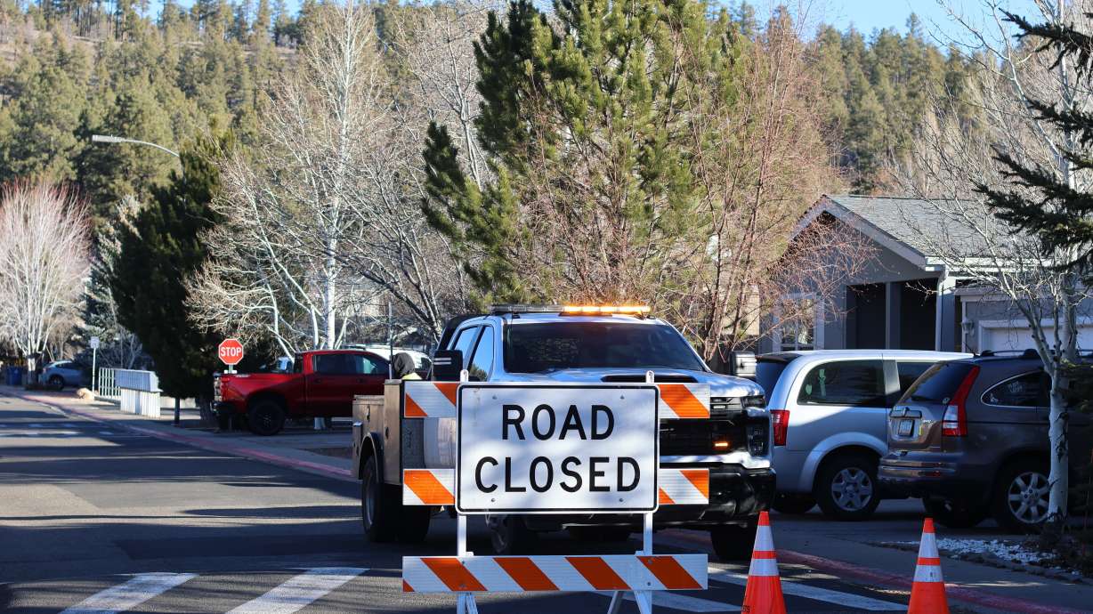 The blocked road to a neighborhood in Flagstaff, Arizona, where police say a man opened fire at officers, Feb. 5. A grand jury indicted 50-year-old Terrell Storey on two counts of first-degree felony murder and dozens of other charges on Friday.