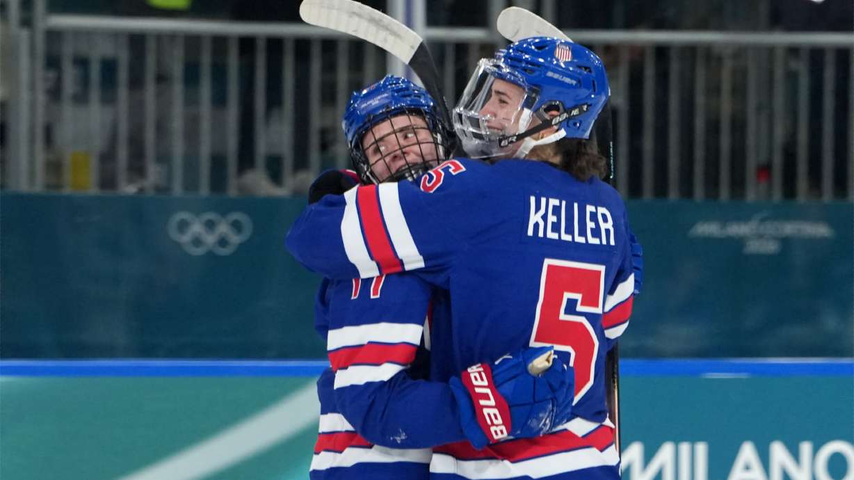 United States' Britta Curl (17) celebrates with Megan Keller (5) after Curl scored a goal against Italy during the second period of a women's ice hockey quarterfinal match at the 2026 Winter Olympics, in Milan, Italy, Friday, Feb. 13, 2026.