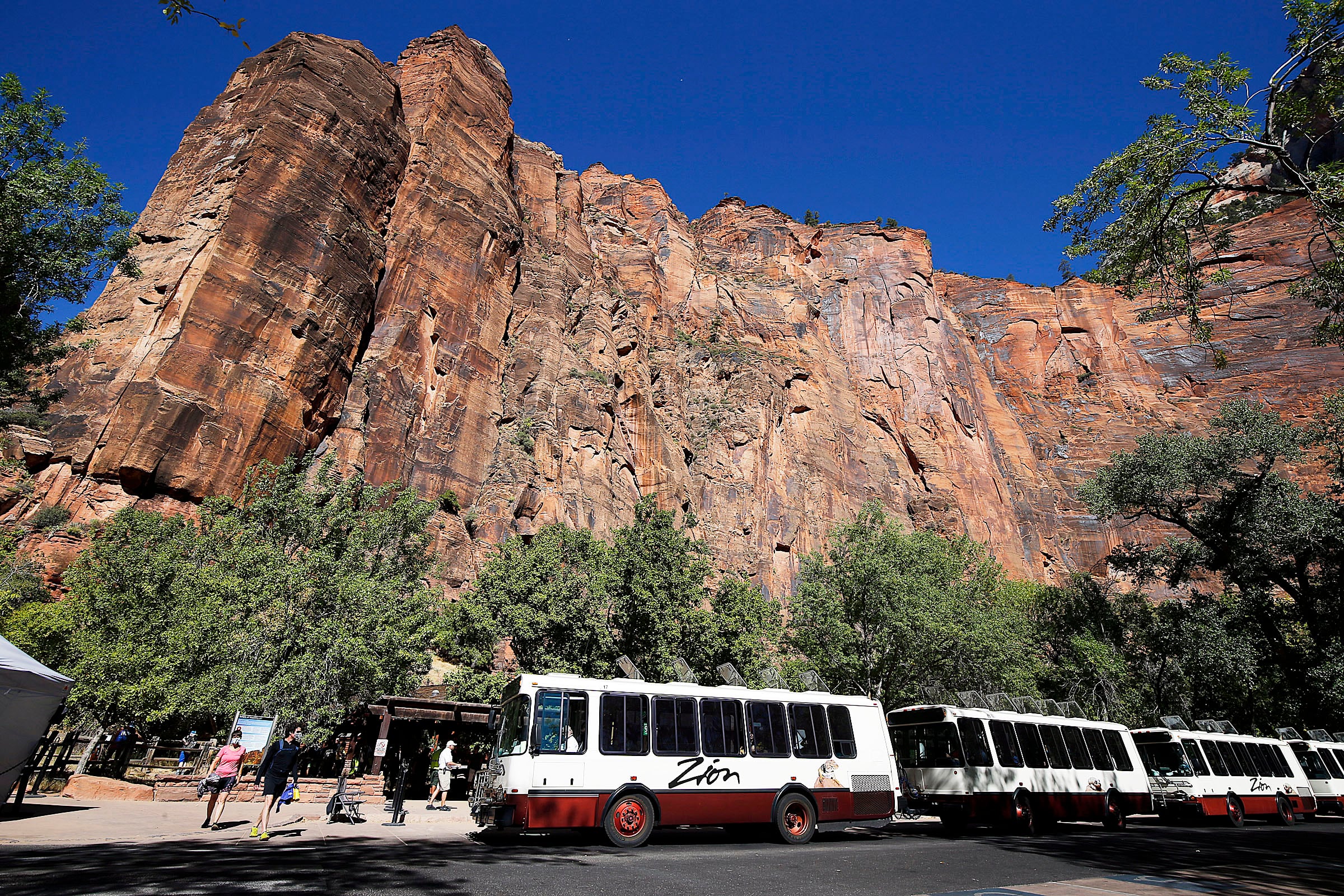 Visitors board shuttles at Zion National Park on Oct. 14, 2020. Staffing cuts could be coming in President Donald Trump's proposed budget for land management next year.