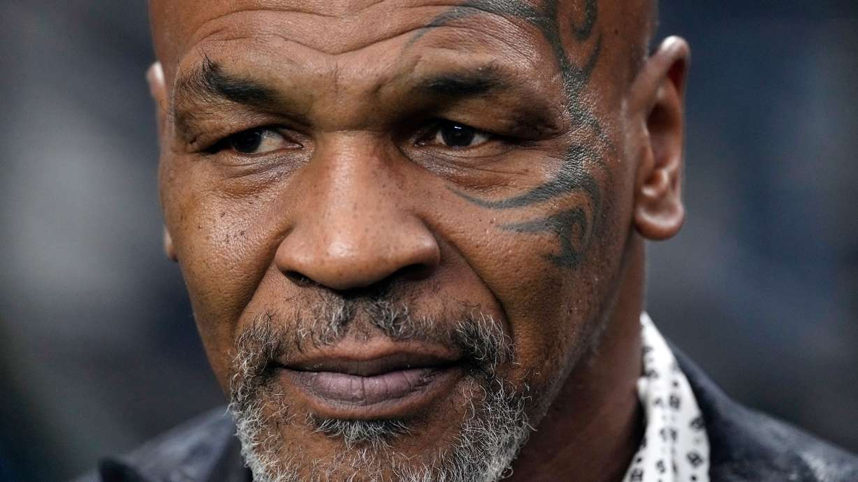 FILE - Former heavyweight boxing champion Mike Tyson stands on the field before an NFL football game between the Las Vegas Raiders and the Pittsburgh Steelers, Sept. 24, 2023, in Las Vegas.