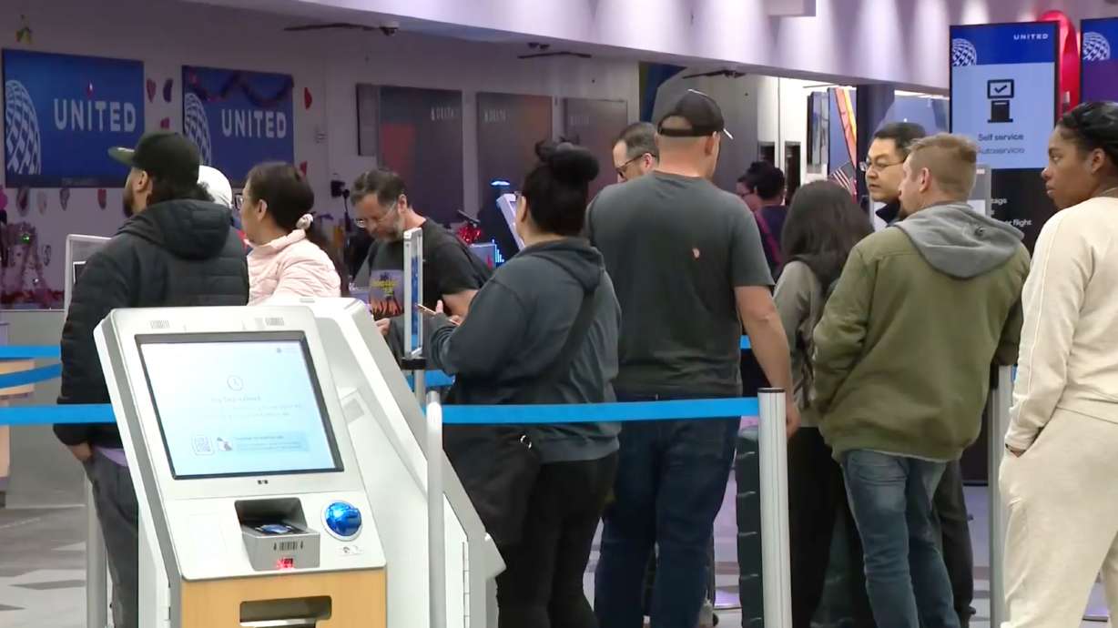 Passengers wait in line at the El Paso International Airport after all flights were grounded on Wednesday, Feb. 11, 2026.