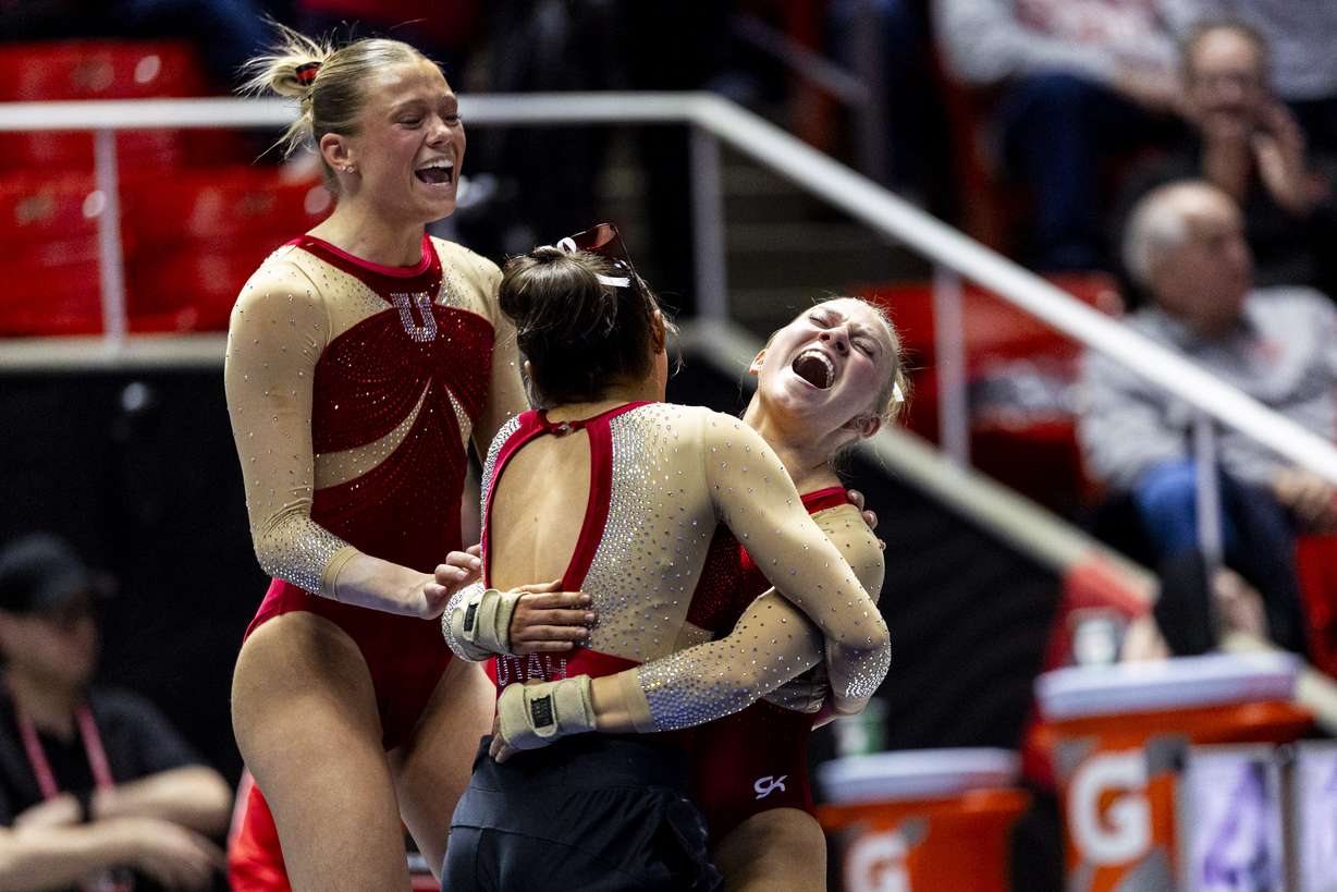 Utah’s Sage Curtis celebrates with her teammates after competing in floor routine during an NCAA gymnastics meet against BYU held at the Huntsman Center in Salt Lake City on Friday, Feb. 13, 2026.