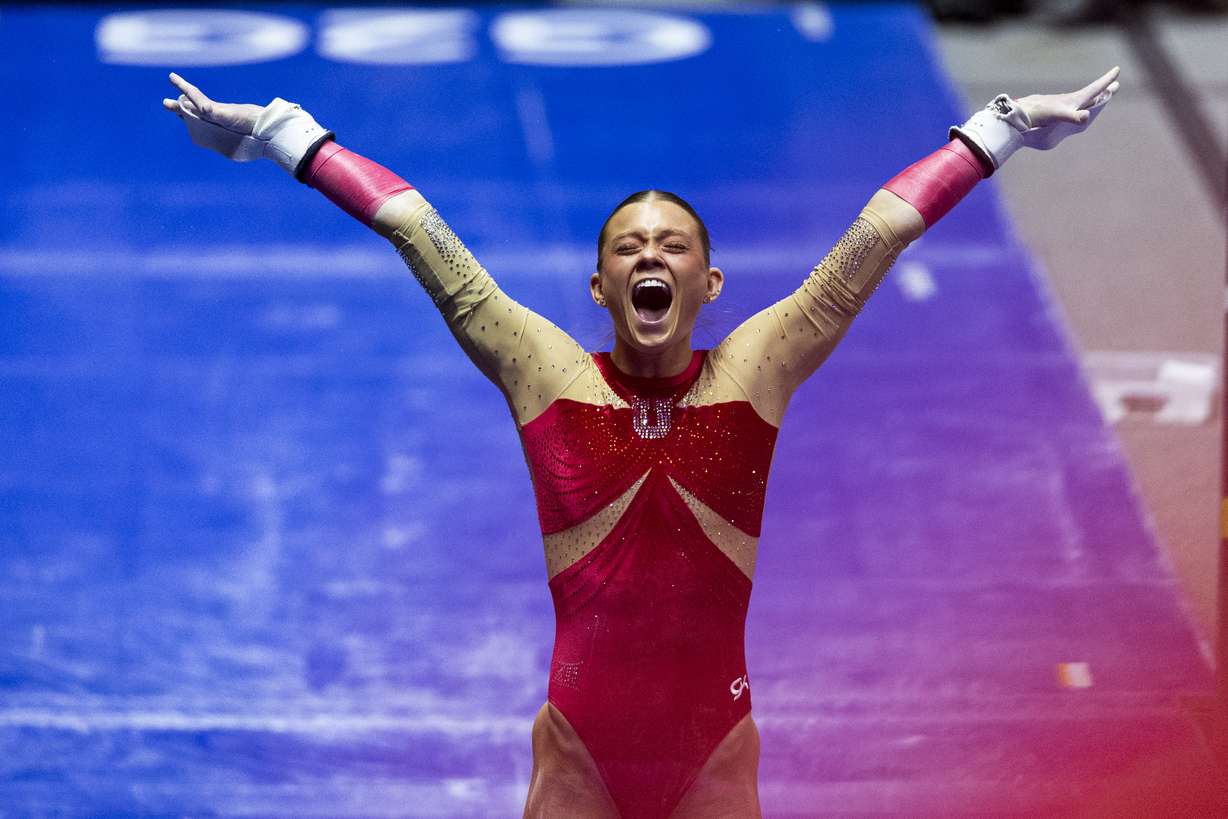 Utah’s Avery Neff celebrates after competing in uneven bars during an NCAA gymnastics meet against BYU held at the Huntsman Center in Salt Lake City on Friday, Feb. 13, 2026.