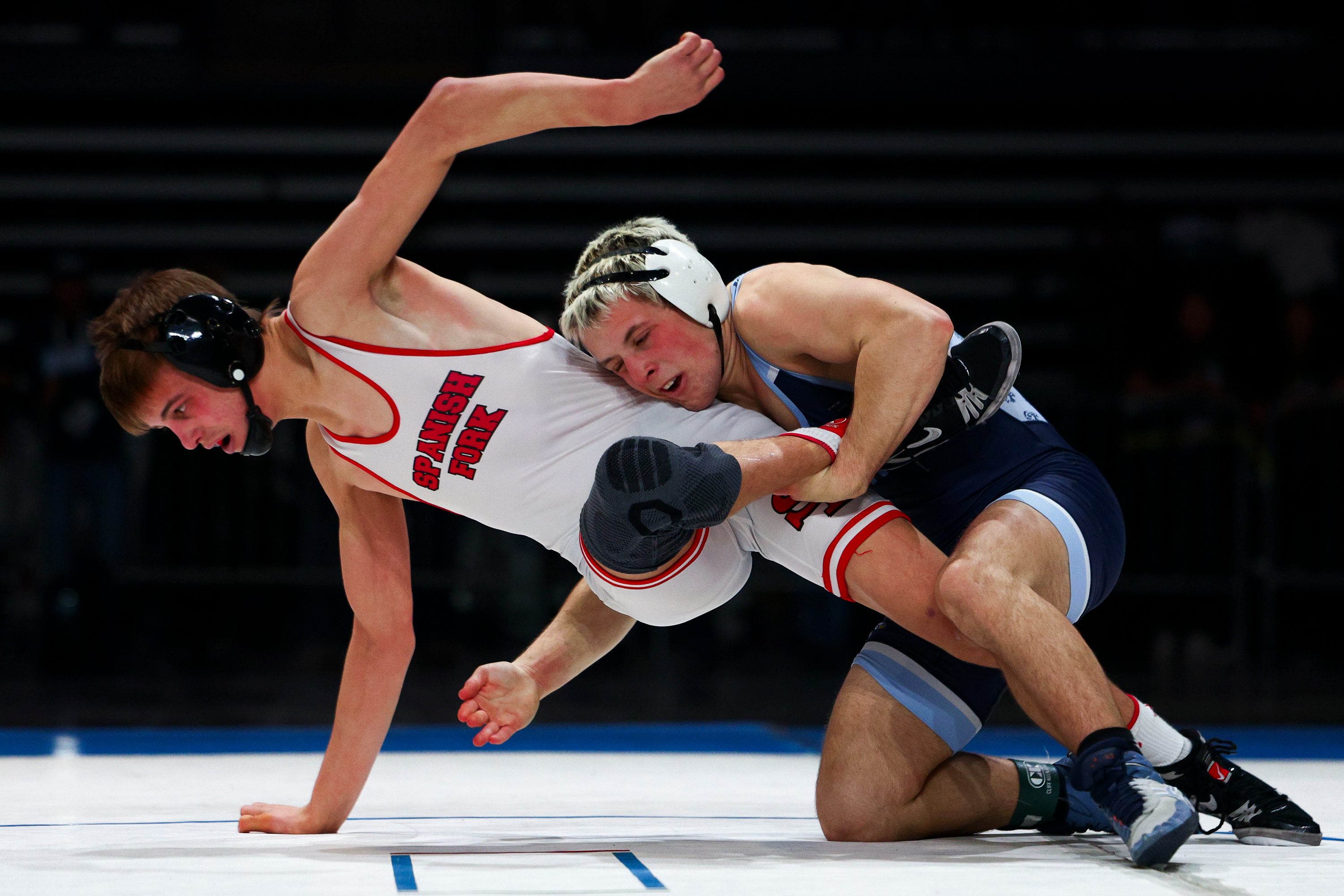 Wrestlers compete during the 5A boys wrestling state championship at the UCCU Center in Orem on Friday, Feb. 13, 2026.