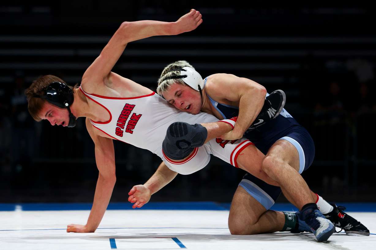 Wrestlers compete during the 5A boys wrestling state championship at the UCCU Center in Orem on Friday, Feb. 13, 2026.