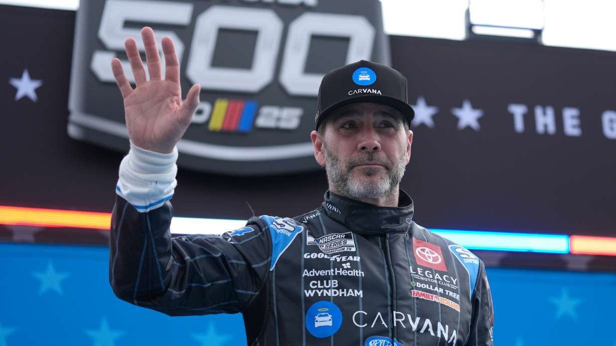 FILE - Jimmie Johnson waves during driver introductions before the NASCAR Daytona 500 auto race at Daytona International Speedway, Feb. 16, 2025, in Daytona Beach, Fla.