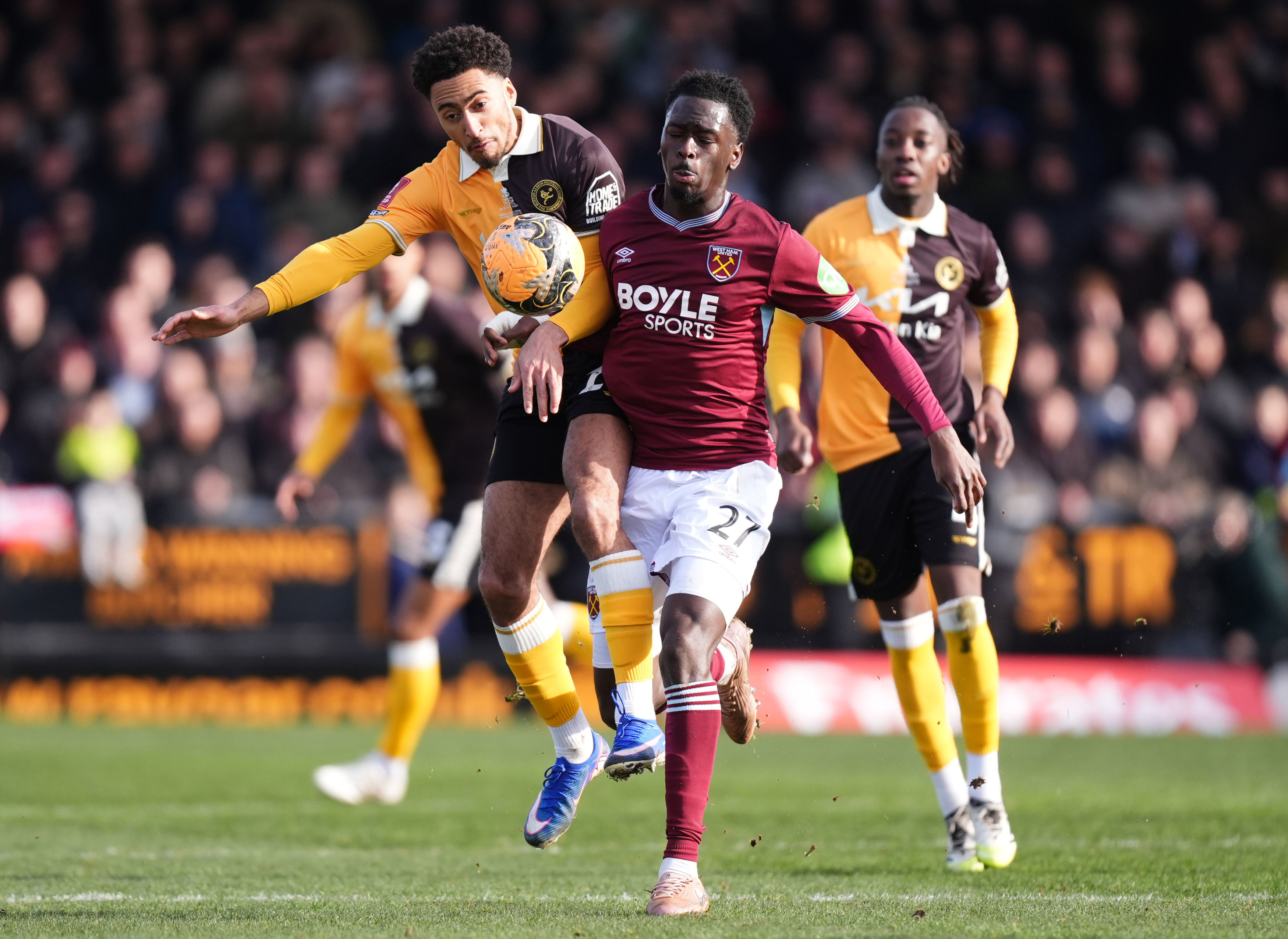 Burton Albion's Kain Adom, left, and West Ham United's Soungoutou Magassa in action during the English FA Cup fourth round soccer match between Burton Albion and West Ham United in Burton upon Trent, England, Saturday Feb. 14, 2026. 