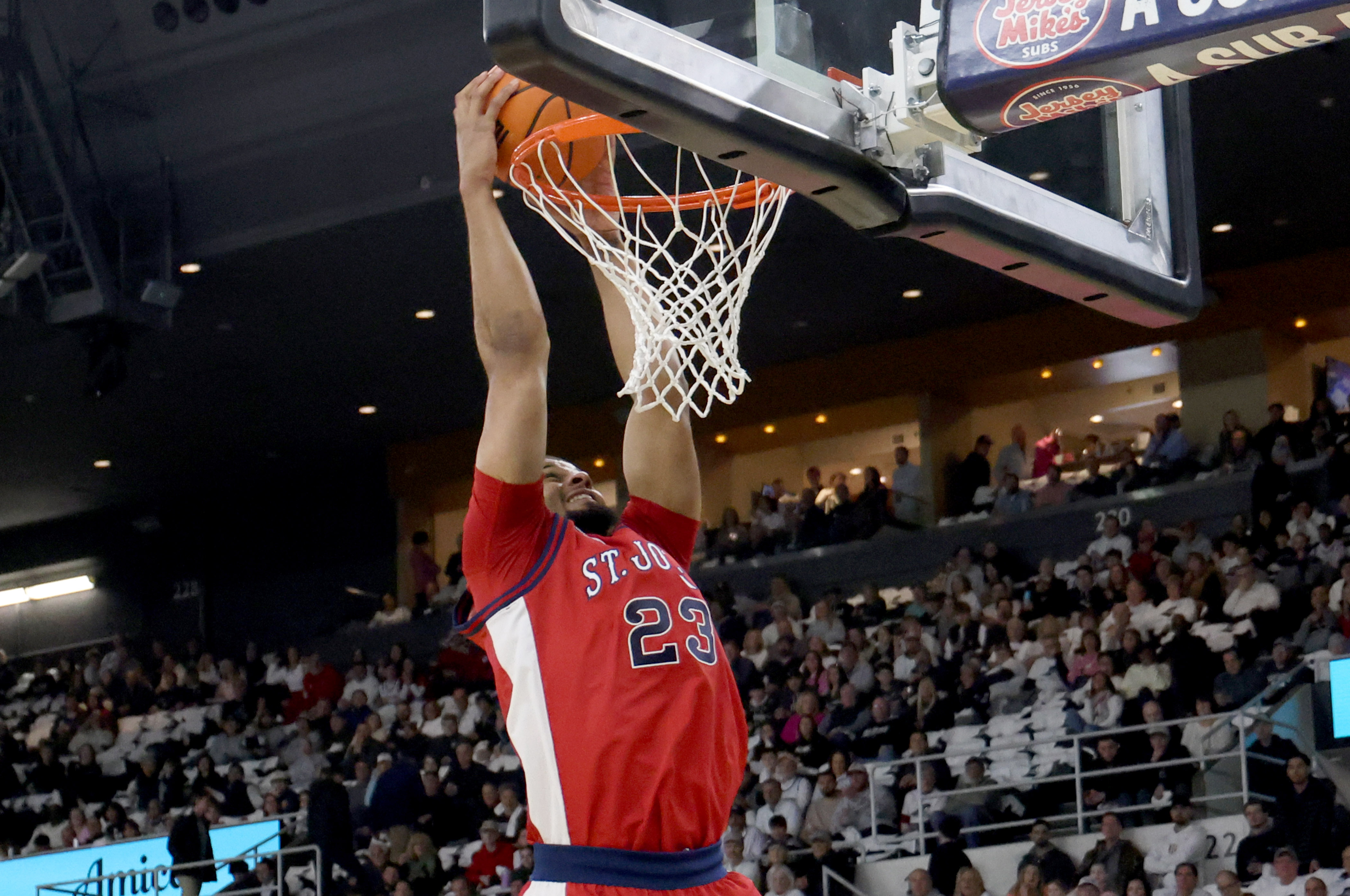 St. John's forward Bryce Hopkins (23) dunks the ball during the first half of an NCAA college basketball game against Providence, Saturday, Feb. 14, 2026, in Providence, R.I. 