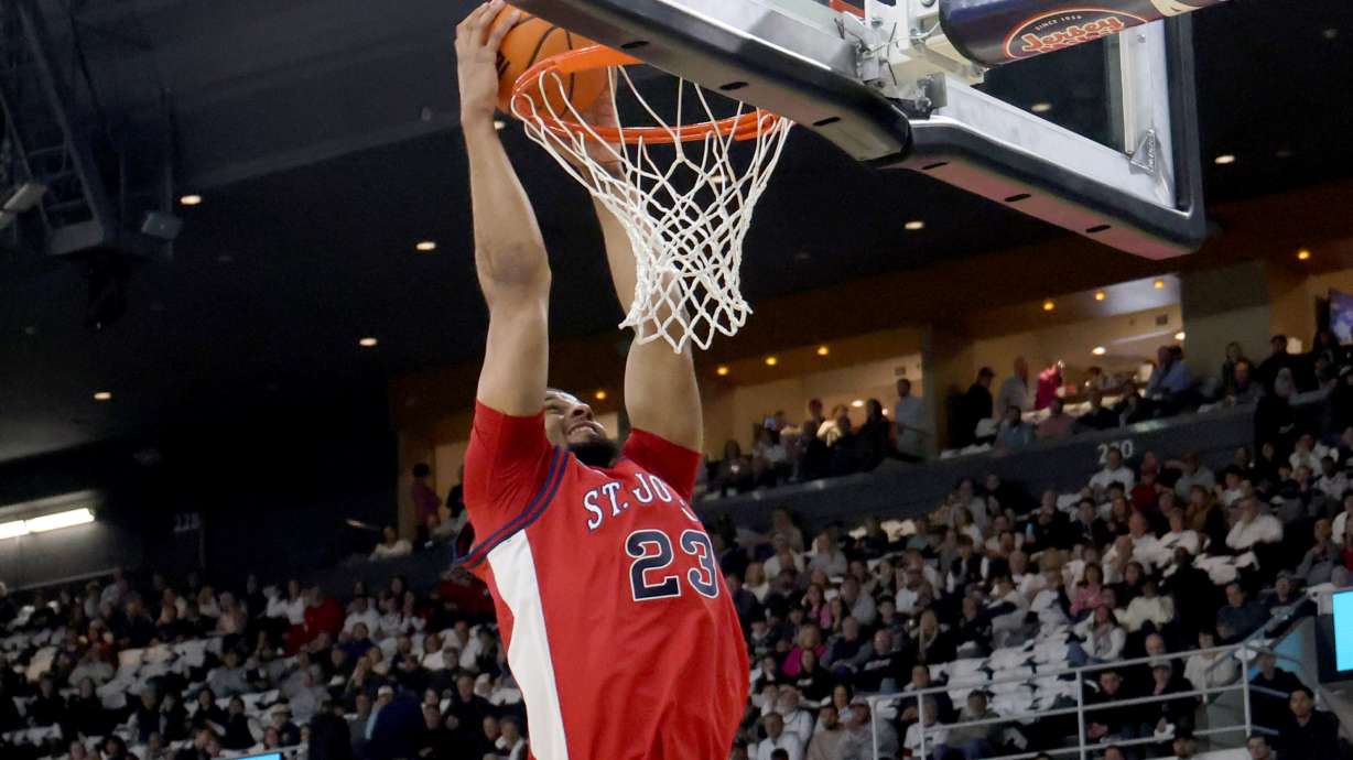 St. John's forward Bryce Hopkins (23) dunks the ball during the first half of an NCAA college basketball game against Providence, Saturday, Feb. 14, 2026, in Providence, R.I.