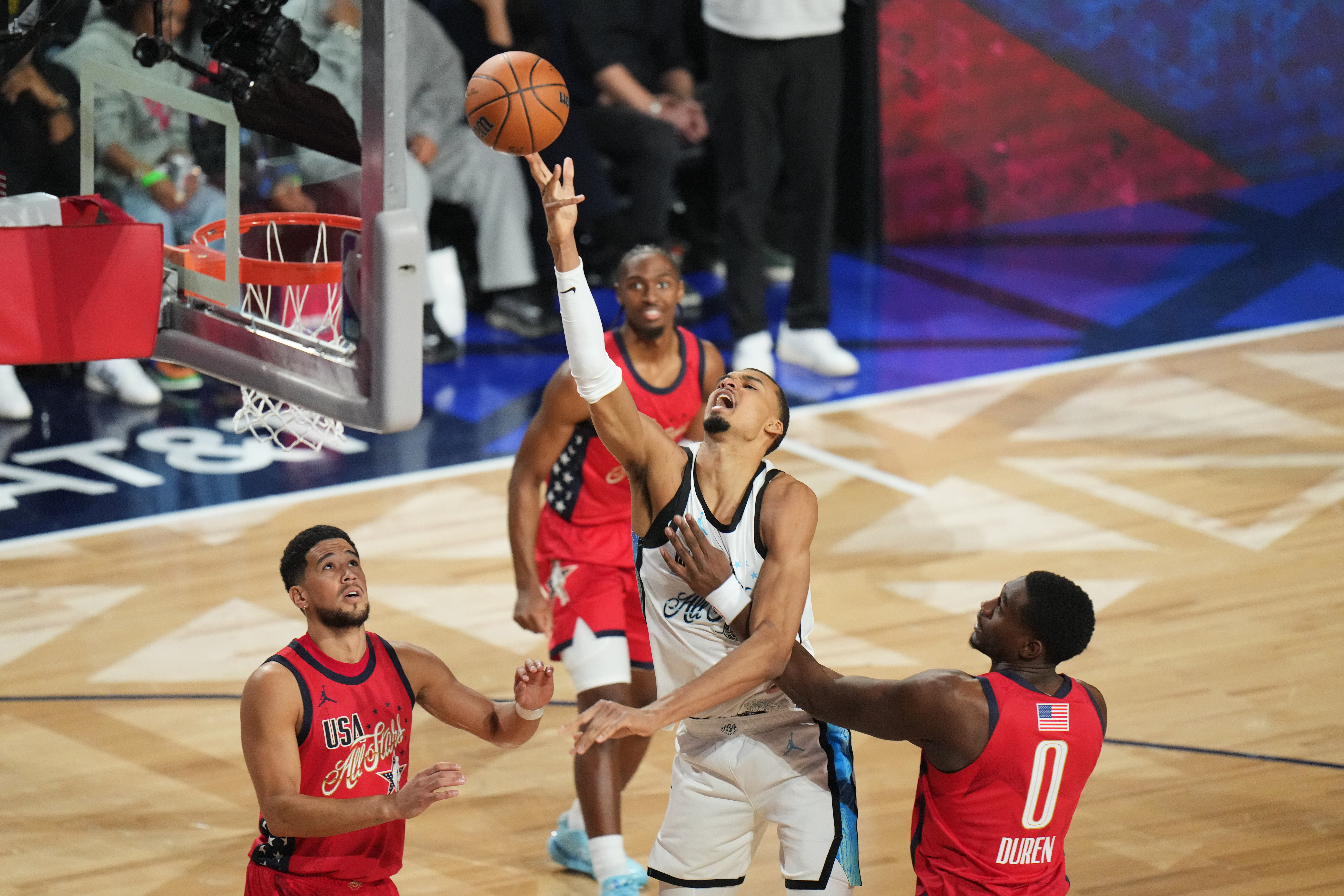 World center Victor Wembanyama, of France, shoots over USA Stars guard Devin Booker, left, and forward Jalen Duren during the NBA All-Star basketball game Sunday, Feb. 15, 2026, in Inglewood, Calif. 