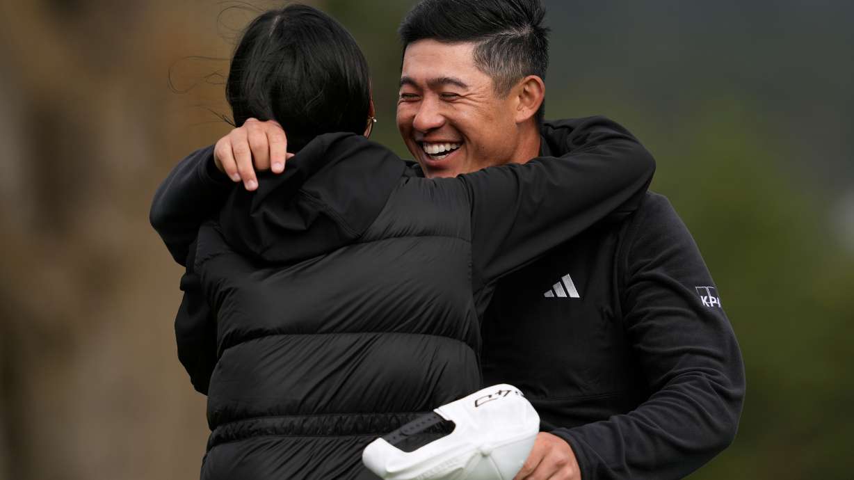 Collin Morikawa, right, celebrates with his wife, Katherine Zhu, after making a birdie putt on the 18th hole at Pebble Beach Golf Links during the final round to win the AT&T Pebble Beach Pro-Am golf tournament in Pebble Beach, Calif., Sunday, Feb. 15, 2026.