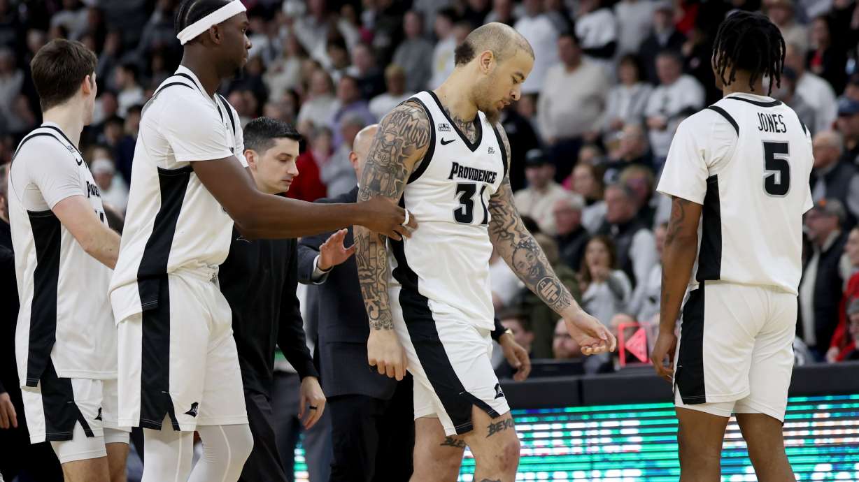 Providence forward Duncan Powell (31) is escorted off the court after getting ejected following a fight during the second half of an NCAA college basketball game against St. John's, Saturday, Feb. 14, 2026, in Providence, R.I.