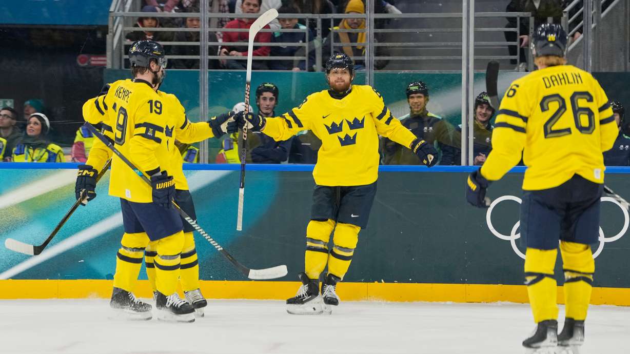 Sweden's William Nylander, center, celebrates after scoring her side's third goal during a preliminary round match of men's ice hockey between Italy and Sweden at the 2026 Winter Olympics, in Milan, Italy, Wednesday, Feb. 11, 2026.