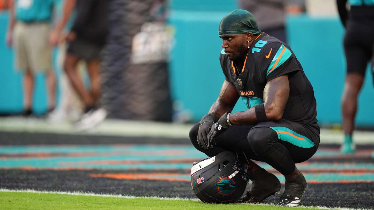 FILE - Miami Dolphins' Tyreek Hill looks toward the field son the sideline before an NFL football game against the New York Jets, Sept. 29, 2025, in Miami Gardens, Fla.