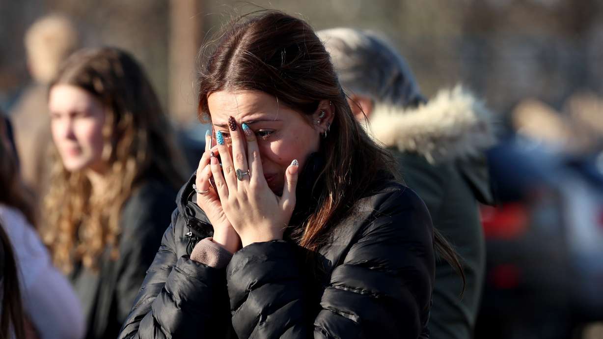 A woman reacts near the Lynch Arena in Pawtucket, R.I., after a shooting at the ice rink, Monday, Feb. 16, 2026.