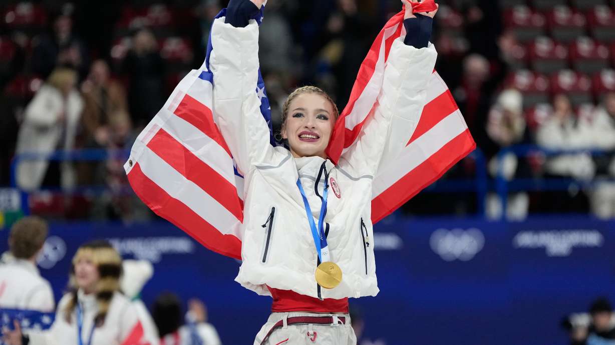 Team USA's Amber Glenn celebrates with her gold medal after the figure skating team event at the 2026 Winter Olympics, in Milan, Italy, Sunday, Feb. 8, 2026.