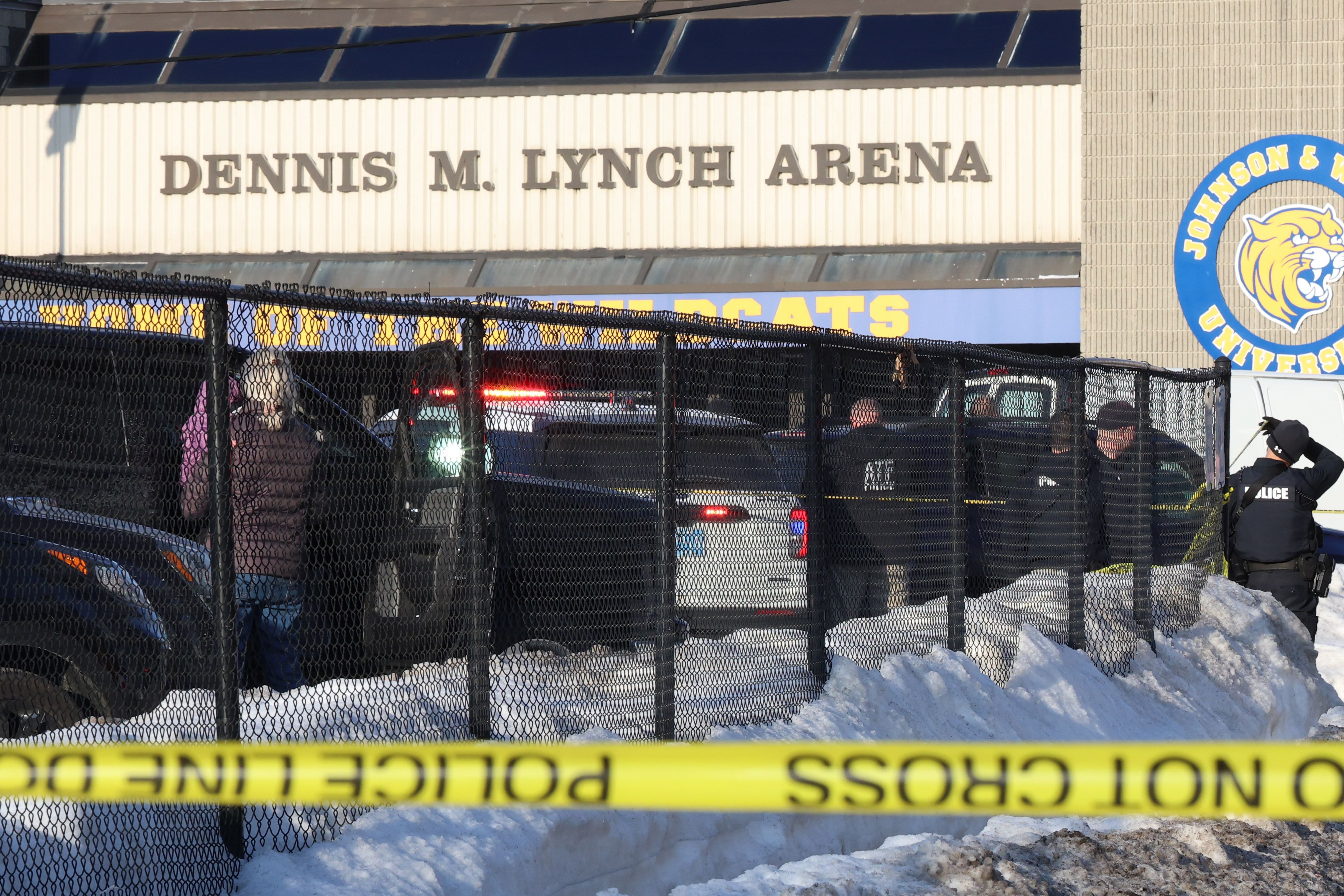 Police and ATF agents stand near the Lynch Arena in Pawtucket, R.I., after a shooting at the ice rink, Monday. Police said the shooter, Robert Dorgan, killed his ex-wife and a son in the shooting.