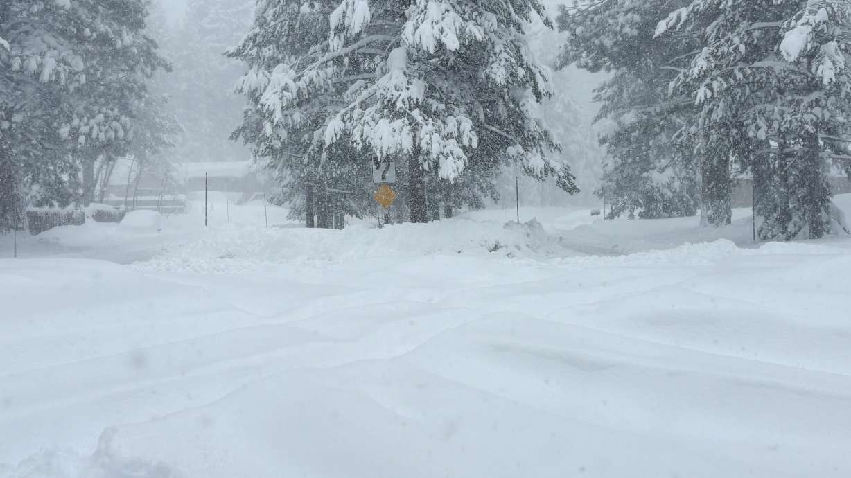 Snow falls on Tuesday in Truckee, Calif. Authorities say six backcountry skiers were found alive, but 10 others are missing after an avalanche in northern California as a powerful winter storm moves through the state.