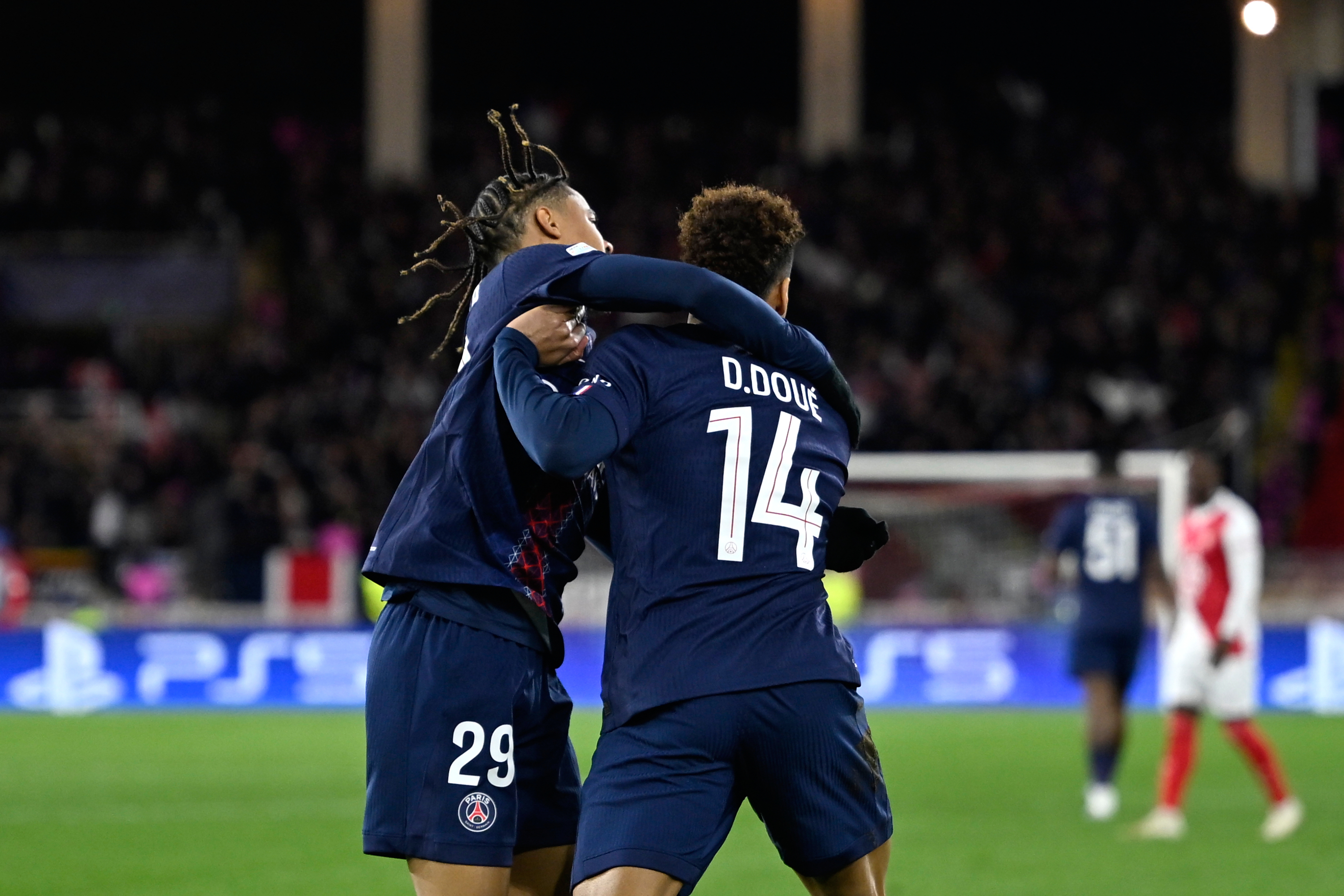 PSG's Desire Doue, right, celebrates with PSG's Bradley Barcola after scoring his side's opening goal during the first-leg of the Champions League playoff soccer match between Monaco and Paris Saint-Germain in Monaco, Tuesday, Feb. 17, 2026. 