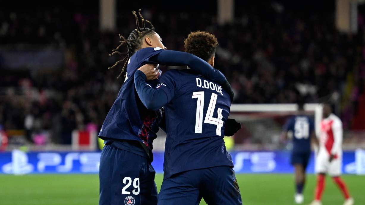PSG's Desire Doue, right, celebrates with PSG's Bradley Barcola after scoring his side's opening goal during the first-leg of the Champions League playoff soccer match between Monaco and Paris Saint-Germain in Monaco, Tuesday, Feb. 17, 2026.