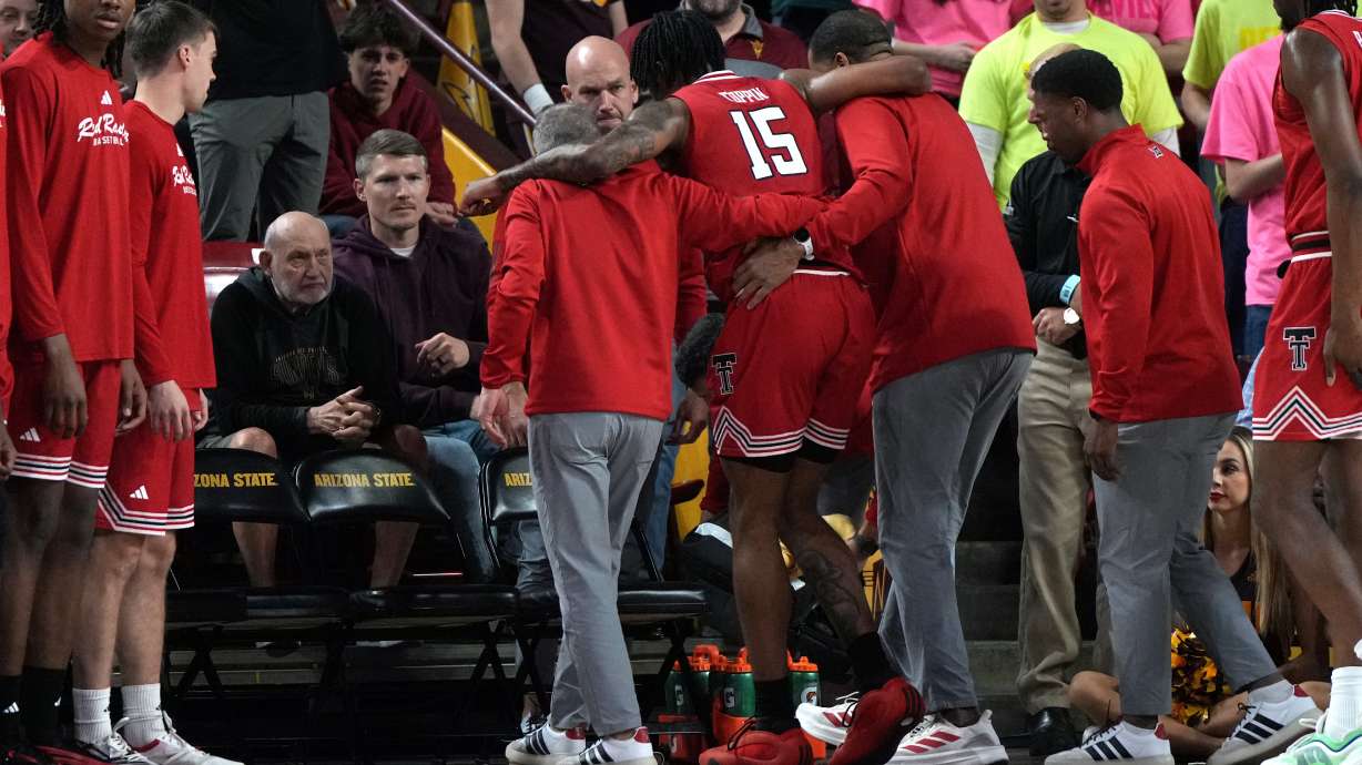 Texas Tech forward JT Toppin (15) gets helped off the court after getting injured against Arizona State during the second half of an NCAA college basketball game, Tuesday, Feb. 17, 2026, in Tempe, Ariz. Toppin did not return to the game.
