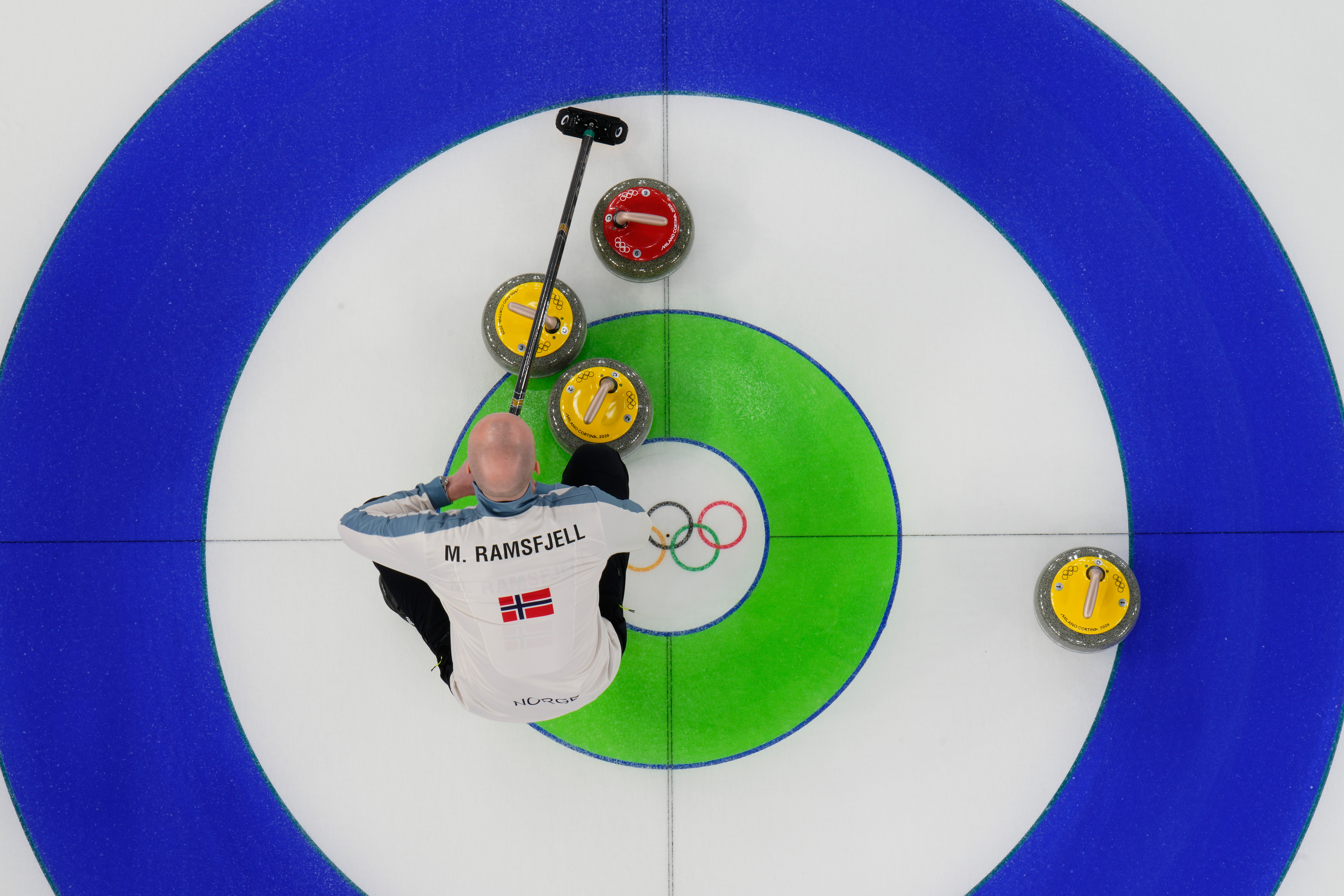 Norway's Magnus Ramsfjell looks over the stones during a men's curling round robin match against China at the 2026 Winter Olympics, in Cortina d'Ampezzo, Italy, Friday, Feb. 13, 2026. 
