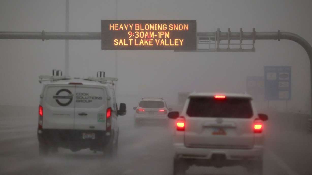 Cars travel on I-15 in a snow storm in Salt Lake County on Wednesday.