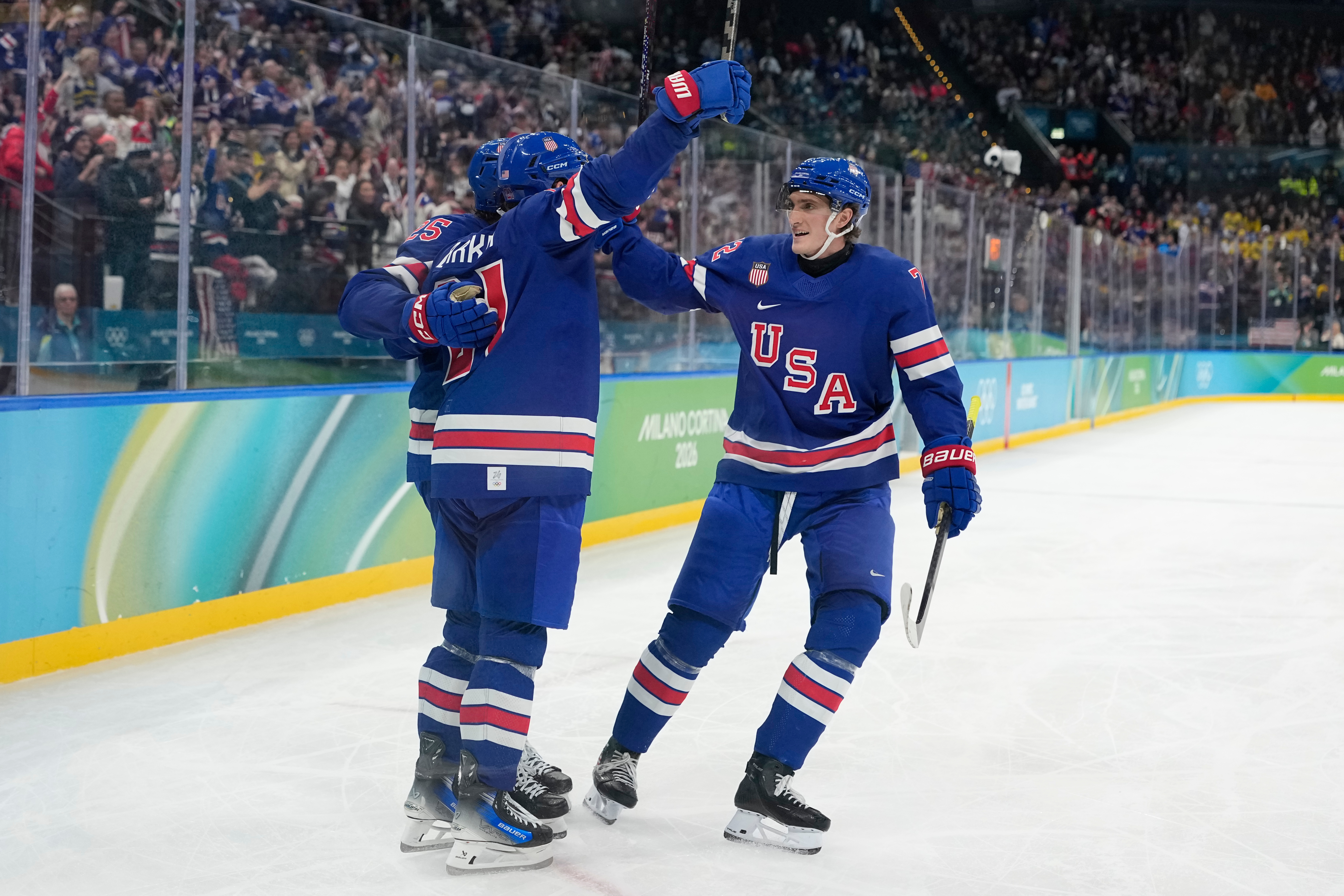 United States' Tage Thompson, right, celebrates with Dylan Larkin (21) after Larkin scored against Sweden during the second period of a men's ice hockey quarterfinal game at the 2026 Winter Olympics, in Milan, Italy, Wednesday, Feb. 18, 2026. 
