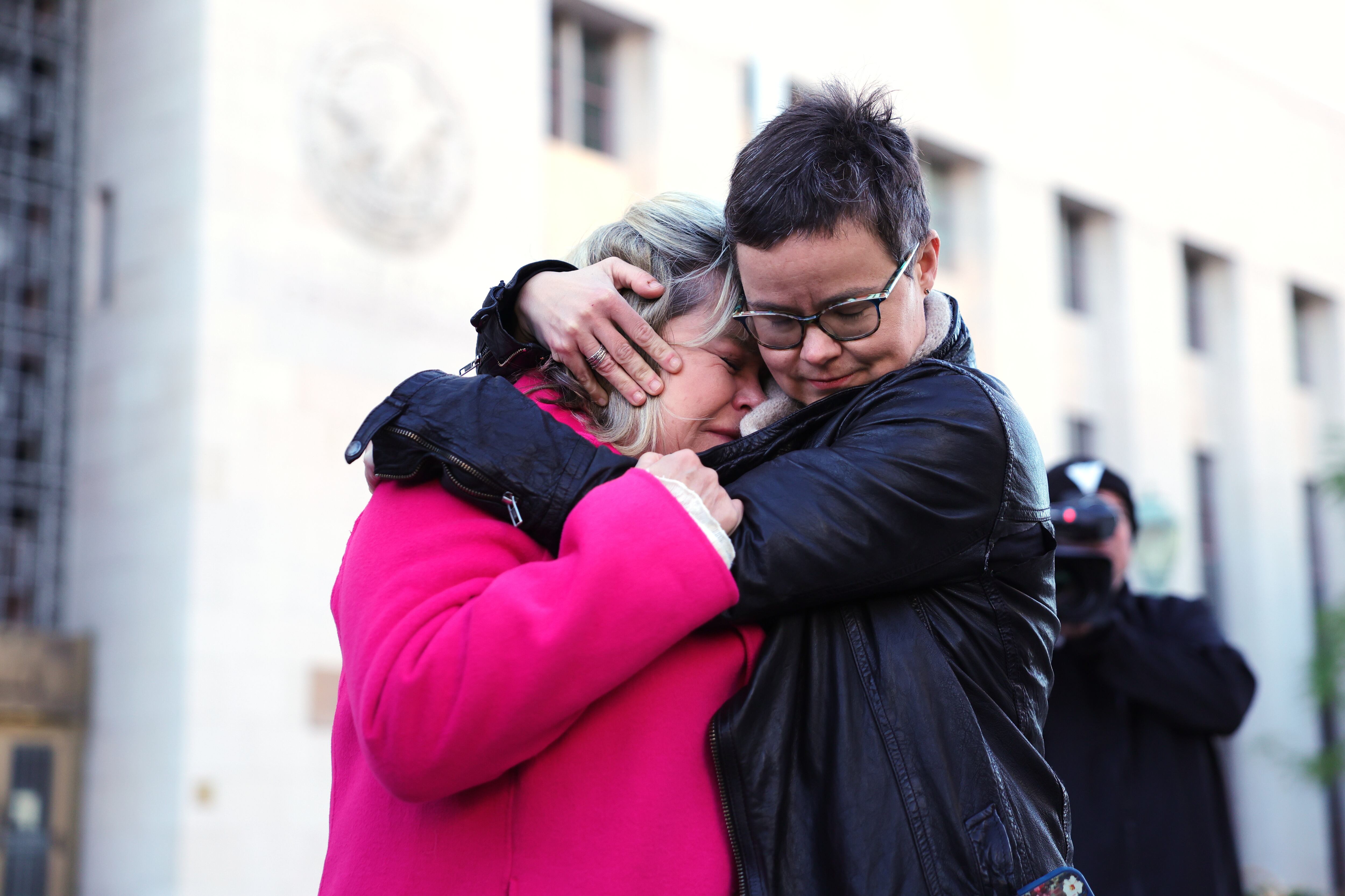 Lennon Flowers, right, Project Director of The Parents' Network, hugs Lori Schott, mother of Annalee Schott, outside a landmark trial over whether social media platforms deliberately addict and harm children, Wednesday, in Los Angeles. The trial could have far-reaching effects.