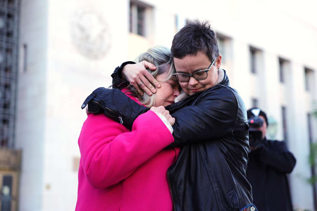 Lennon Flowers, right, Project Director of The Parents' Network, hugs Lori Schott, mother of Annalee Schott, outside a landmark trial over whether social media platforms deliberately addict and harm children, Wednesday, in Los Angeles. The trial could have far-reaching effects.