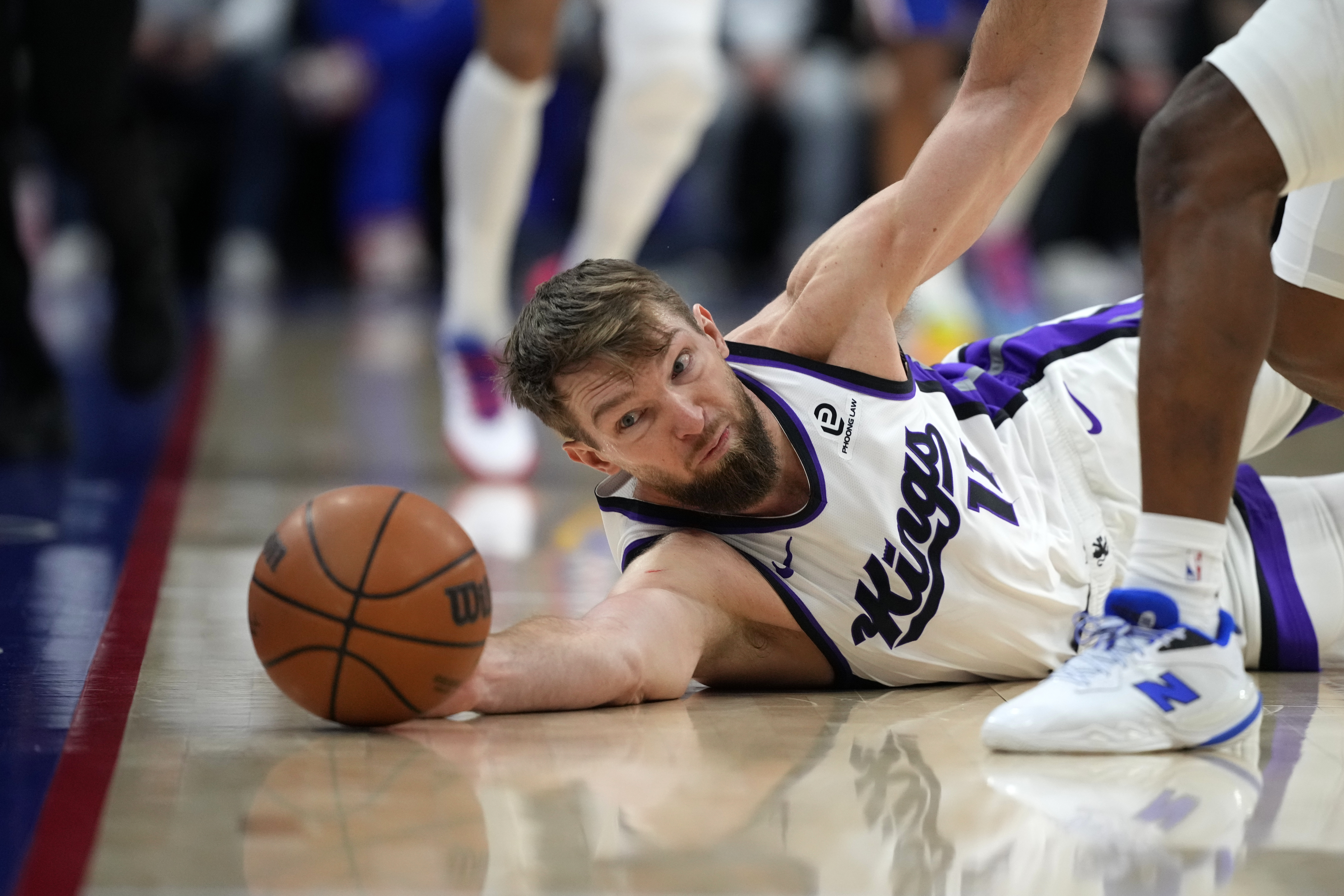 Sacramento Kings' Domantas Sabonis tries to save a lose ball during the first half of an NBA basketball game against the Philadelphia 76ers Thursday, Jan. 29, 2026, in Philadelphia.