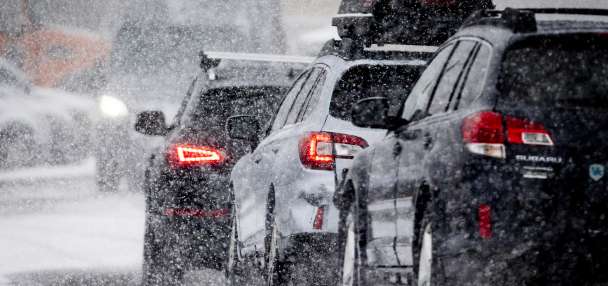Heavy snow causes delays at airport, snow squall warnings and canyon restrictions